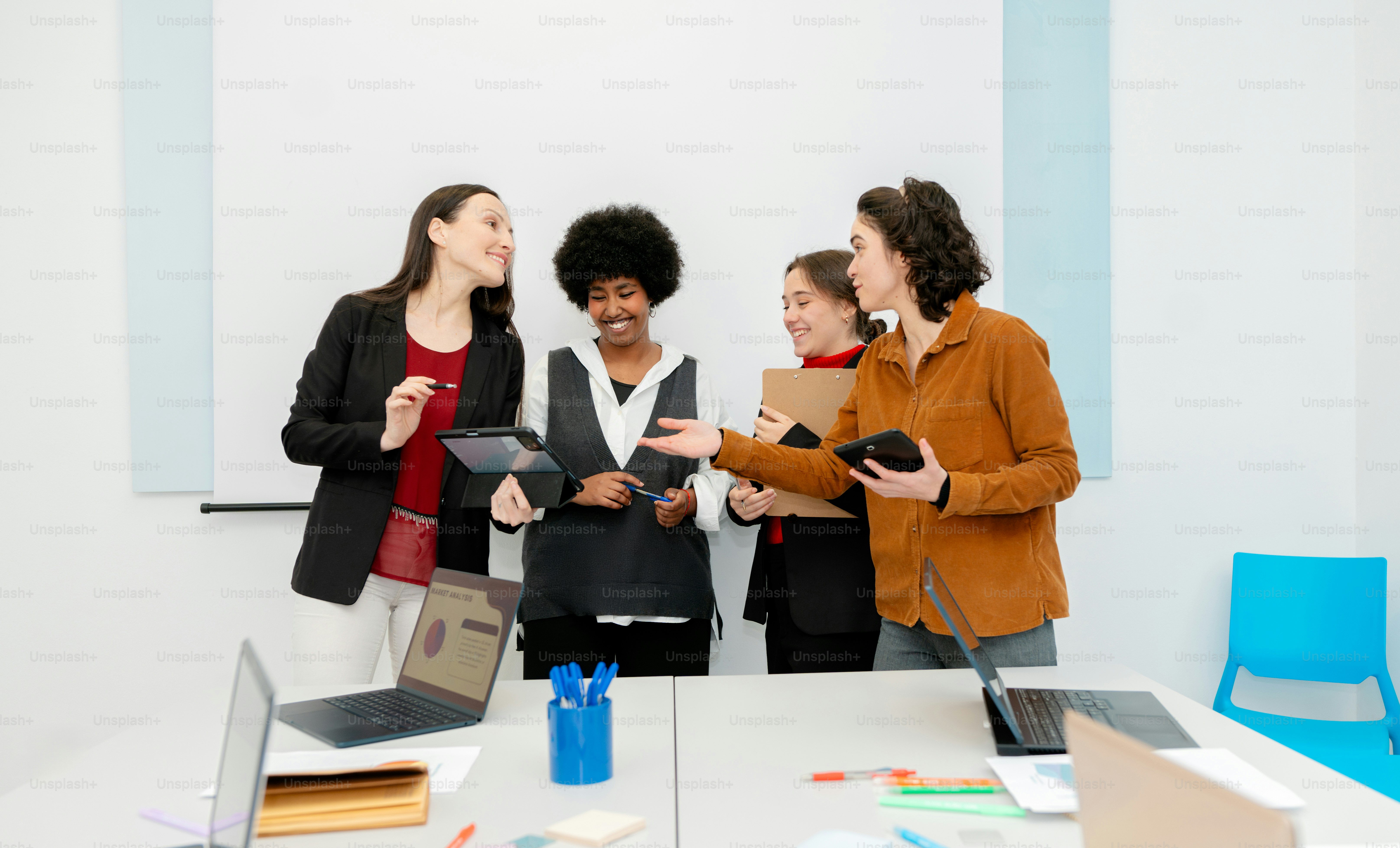 A group of people standing around a table