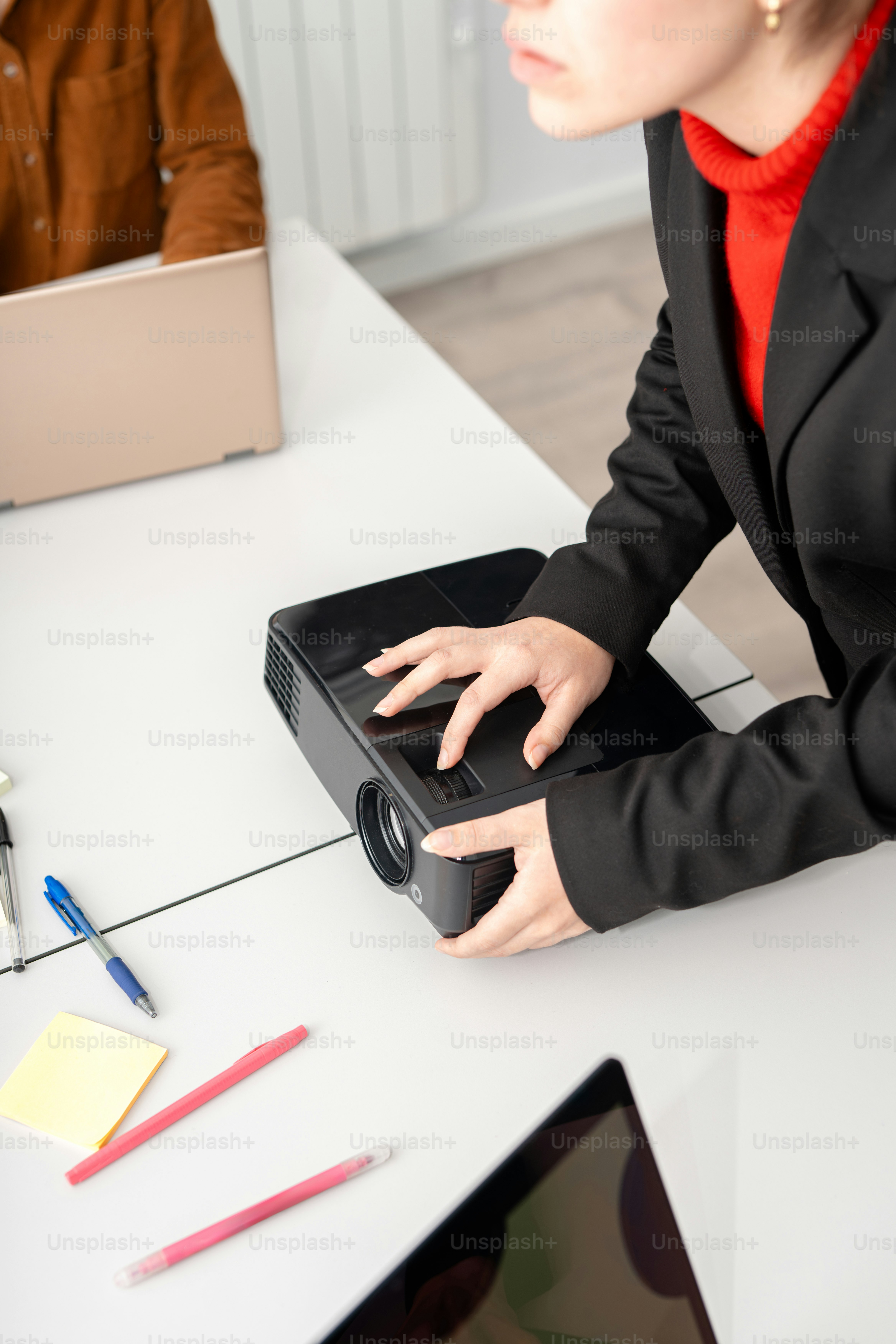 A woman sitting at a desk with a laptop
