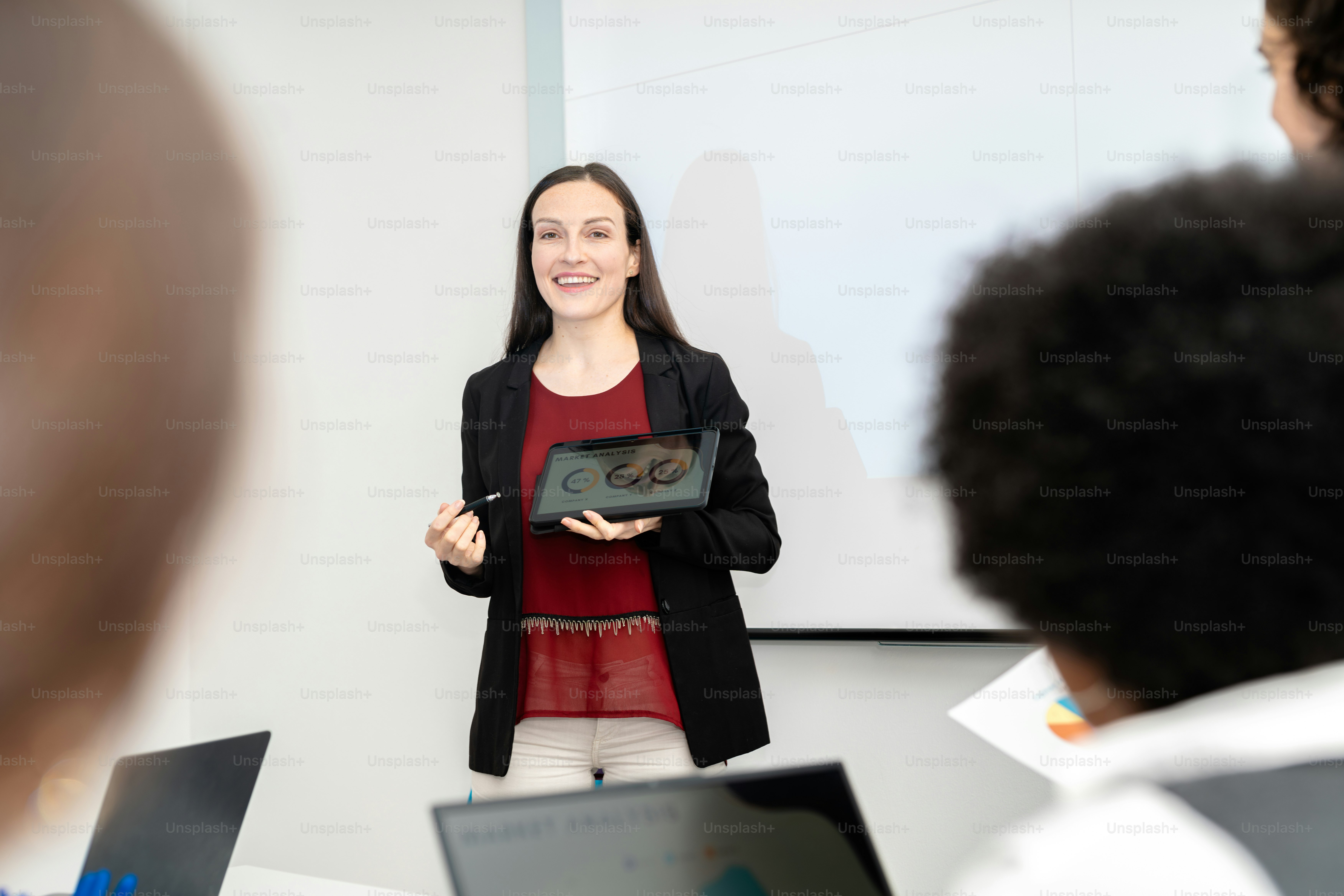 A woman standing in front of a group of laptops