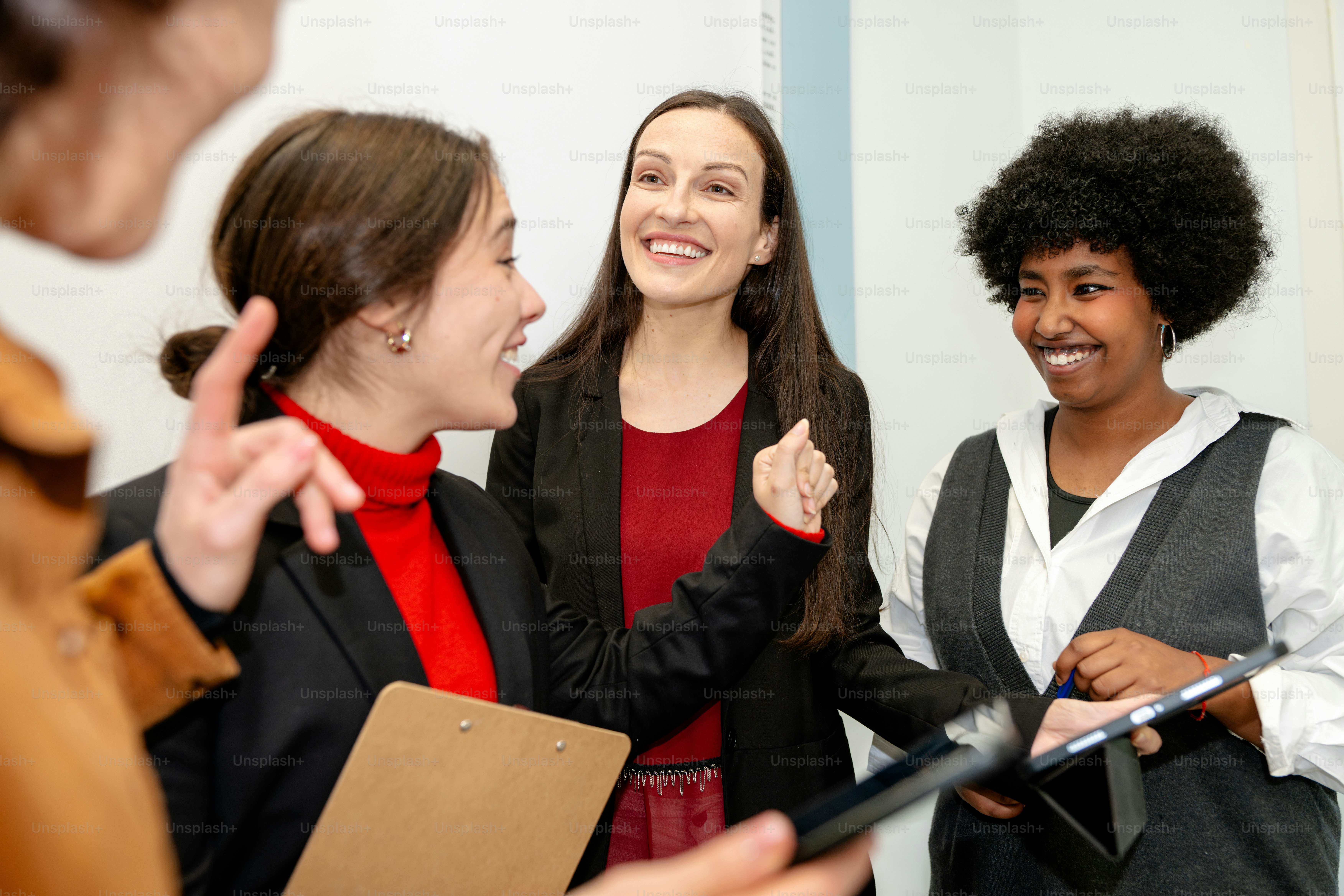 A group of women standing around each other