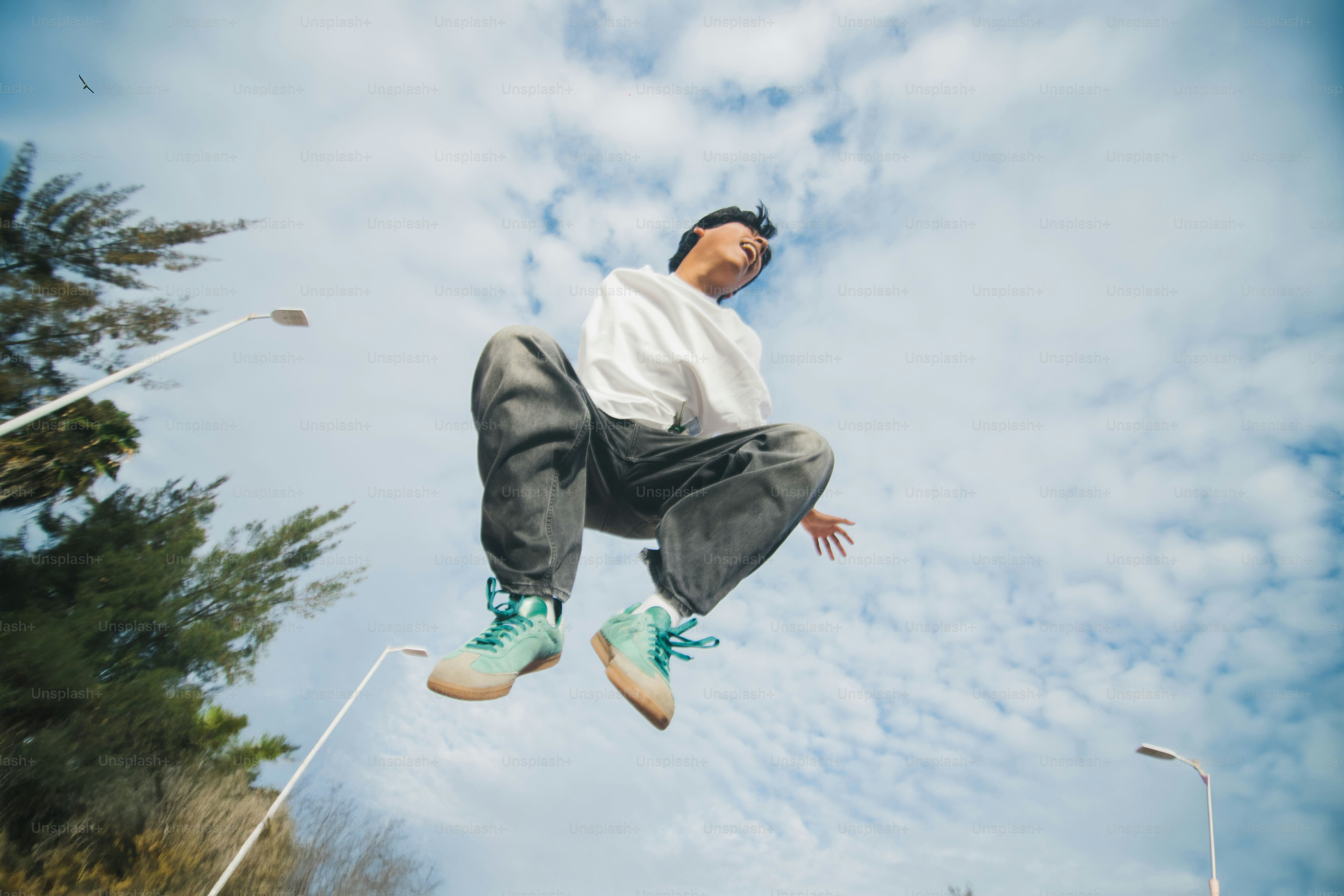 A man flying through the air while riding a skateboard photo – Gen z ...