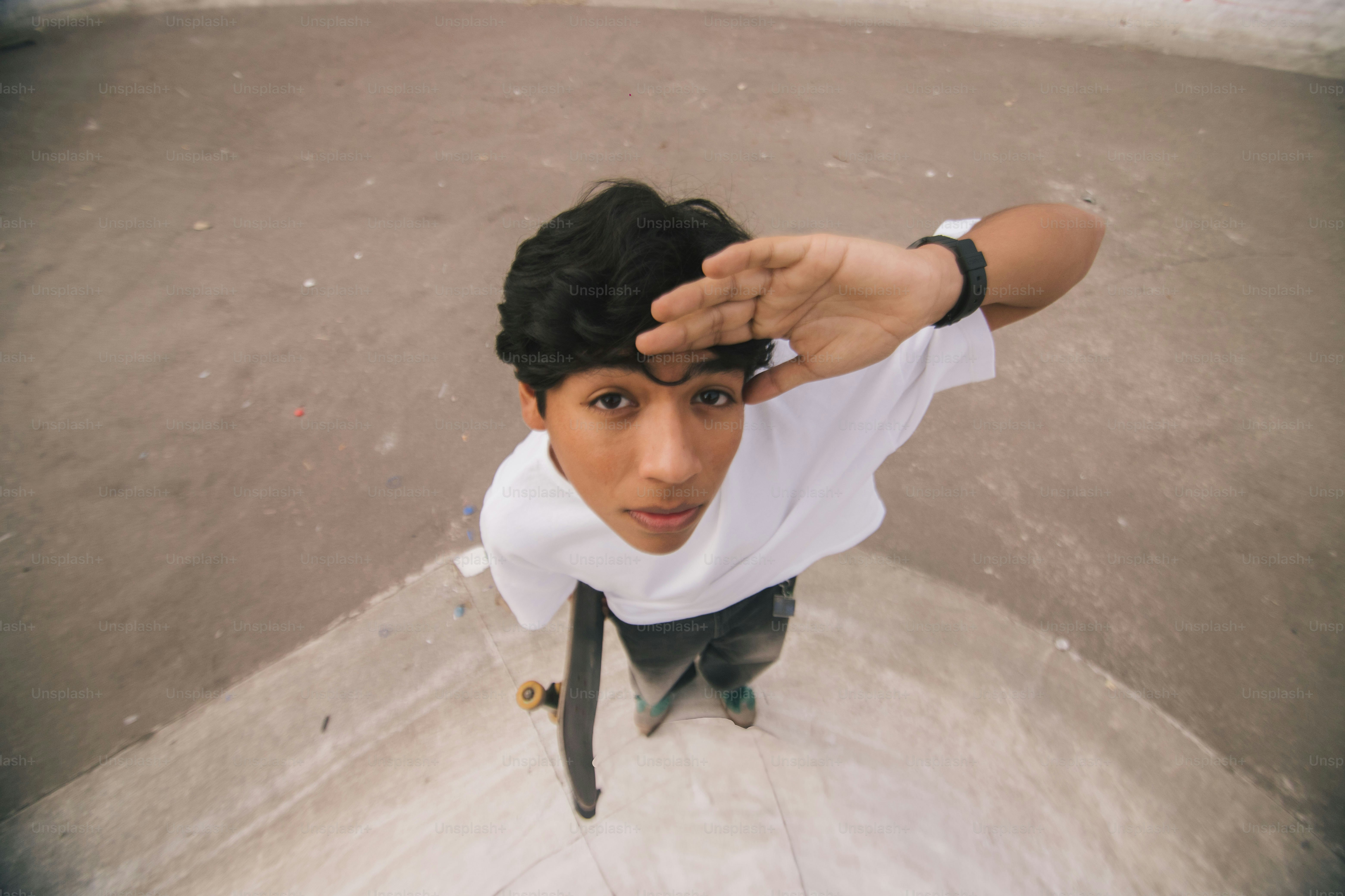 A young man riding a skateboard up the side of a ramp