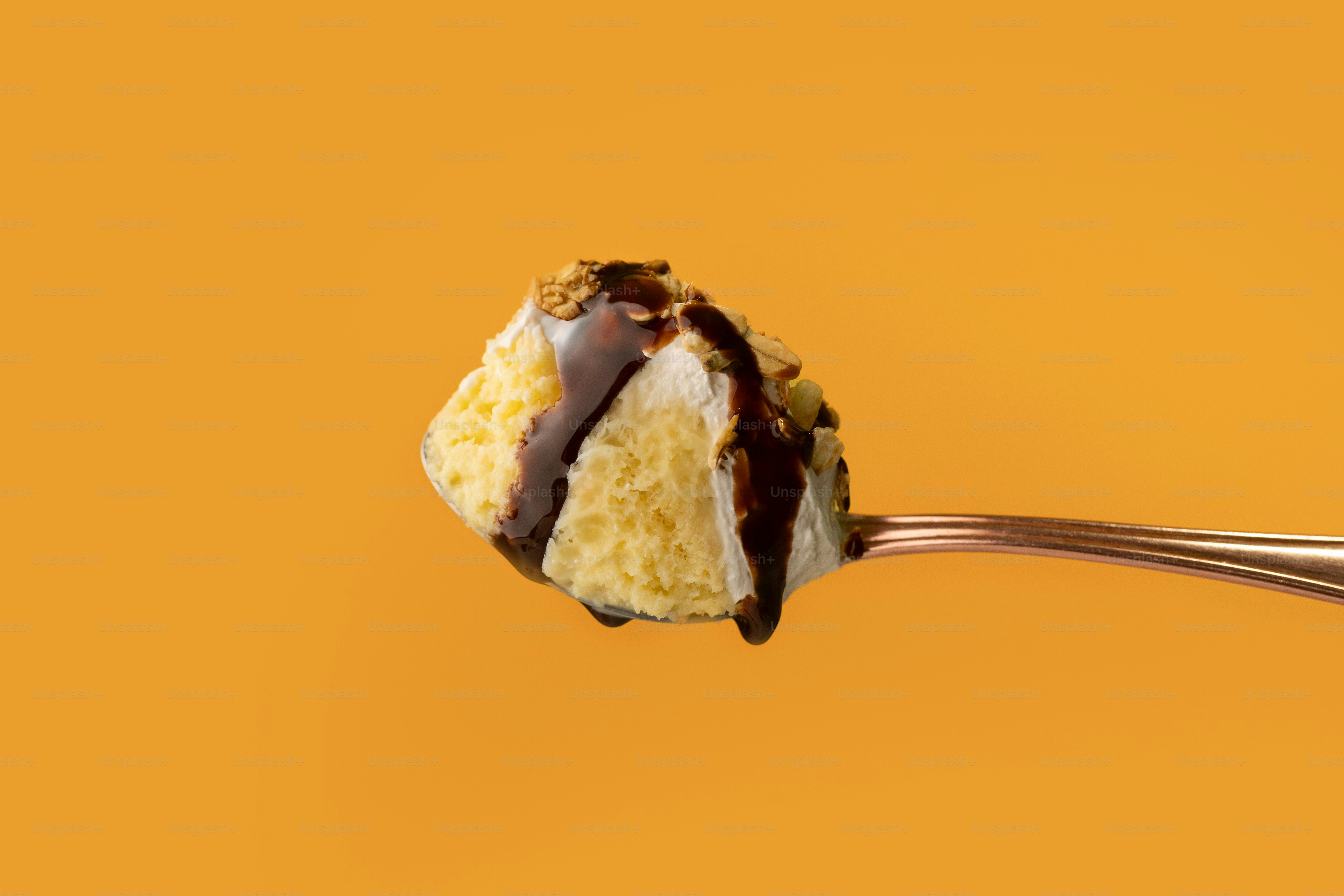 A piece of cake on a fork with a bite taken out of it