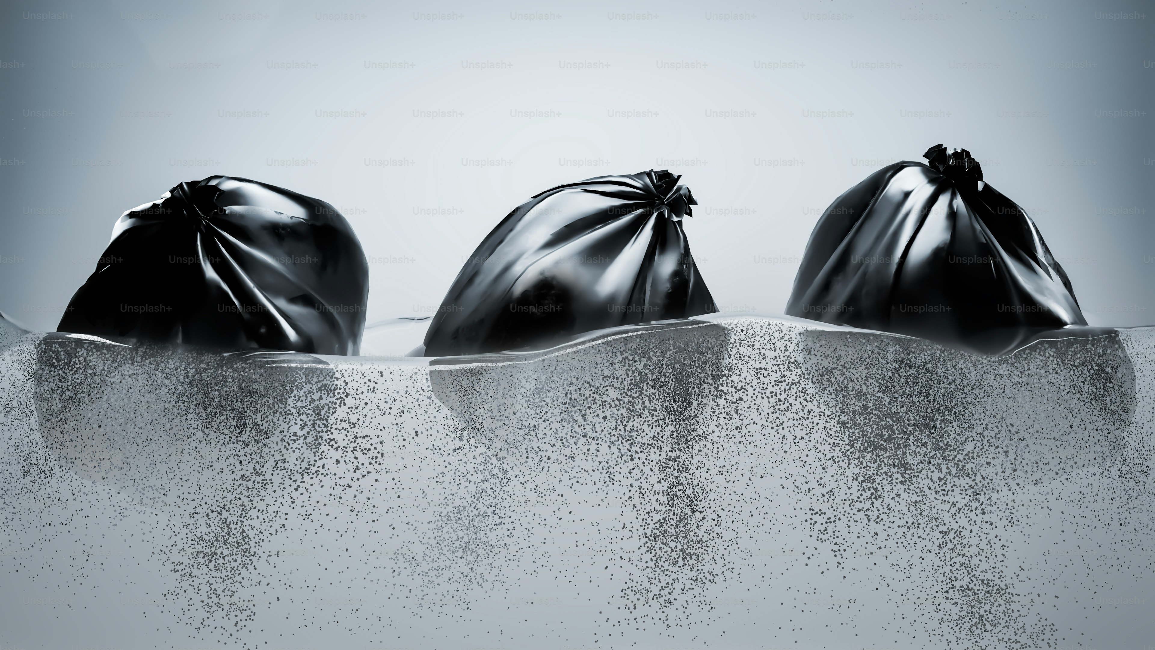 Three bags of sand sitting in the middle of a body of water