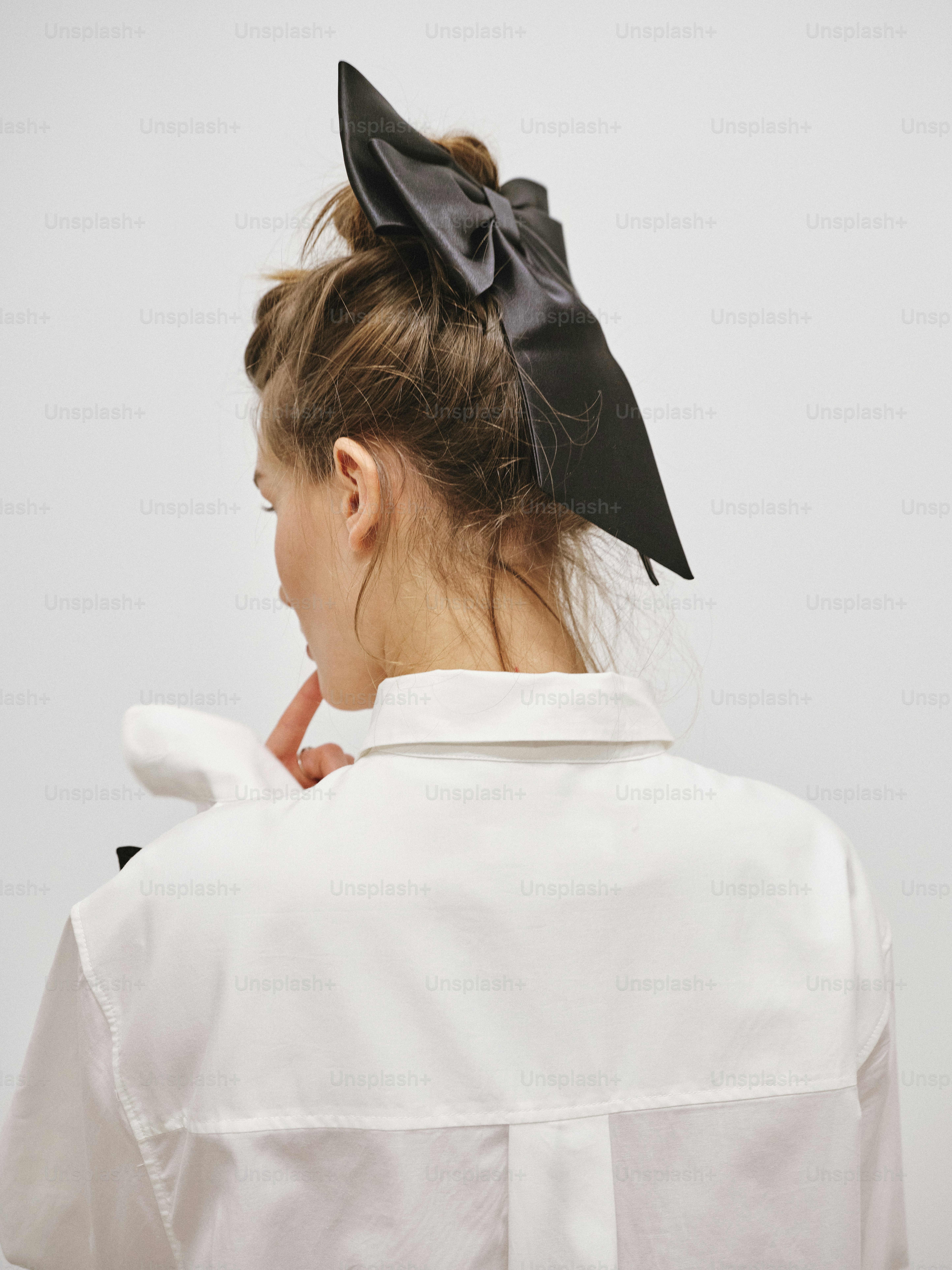 A woman with a black bow on her head