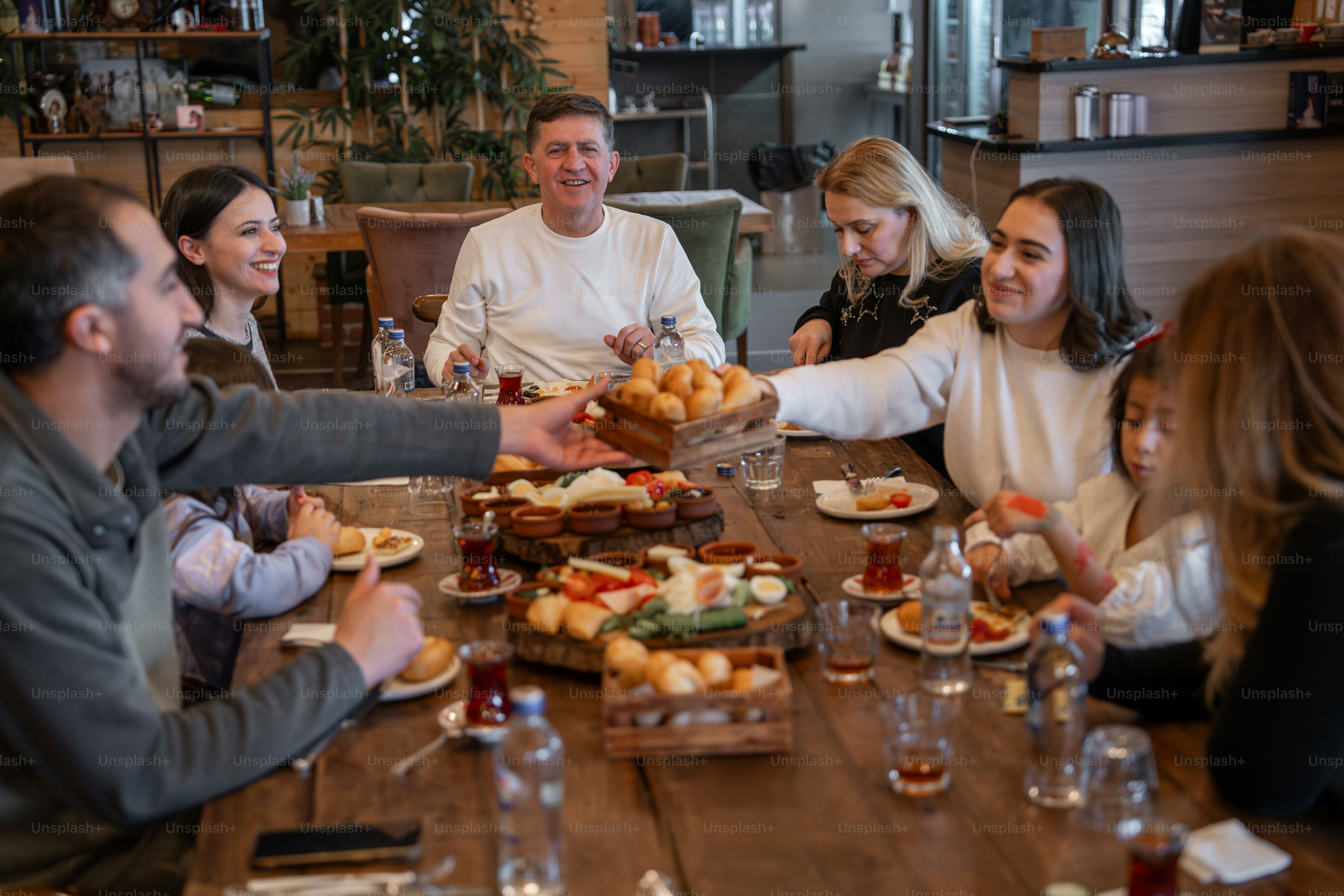 A group of people sitting around a wooden table