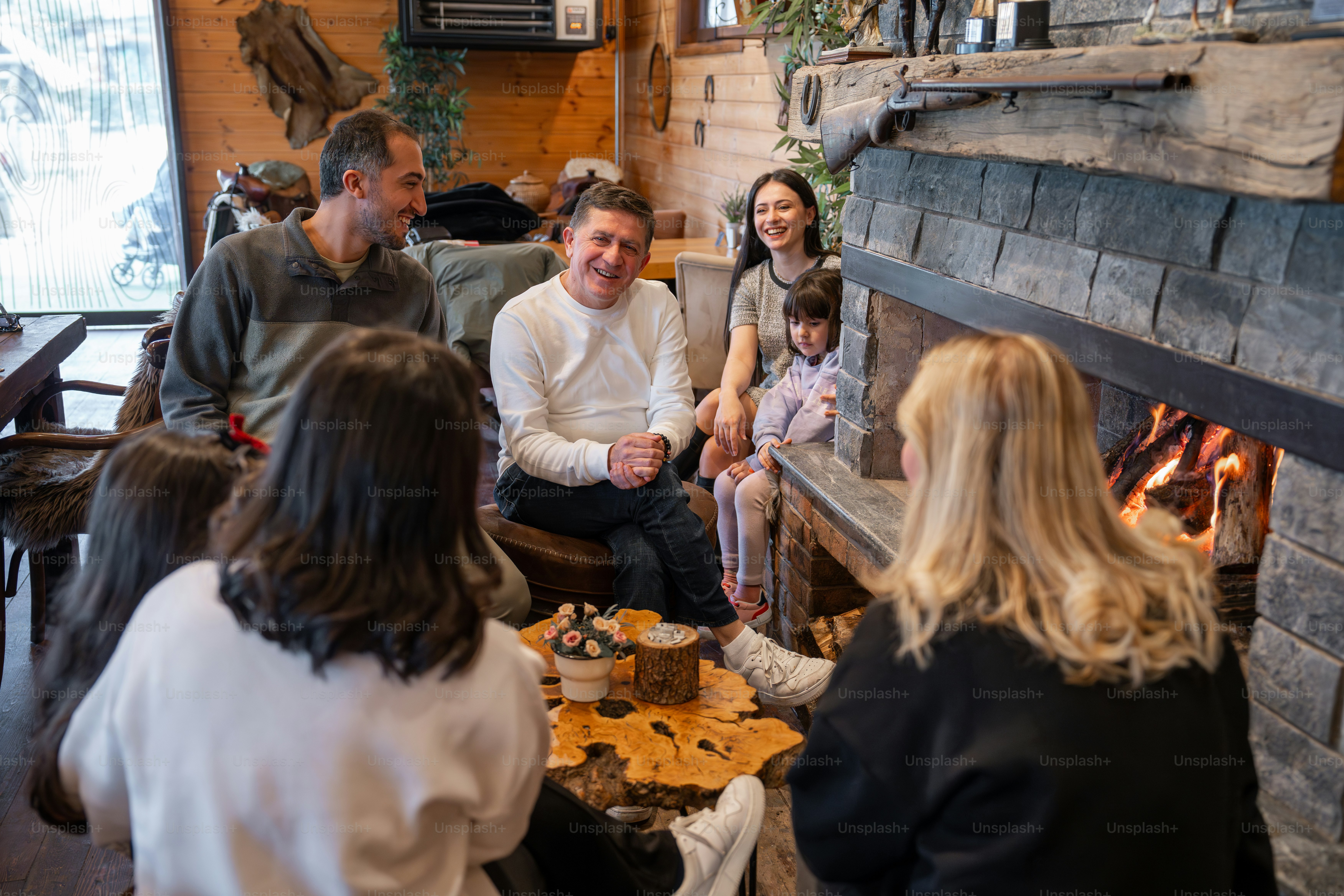 A group of people sitting around a fire place