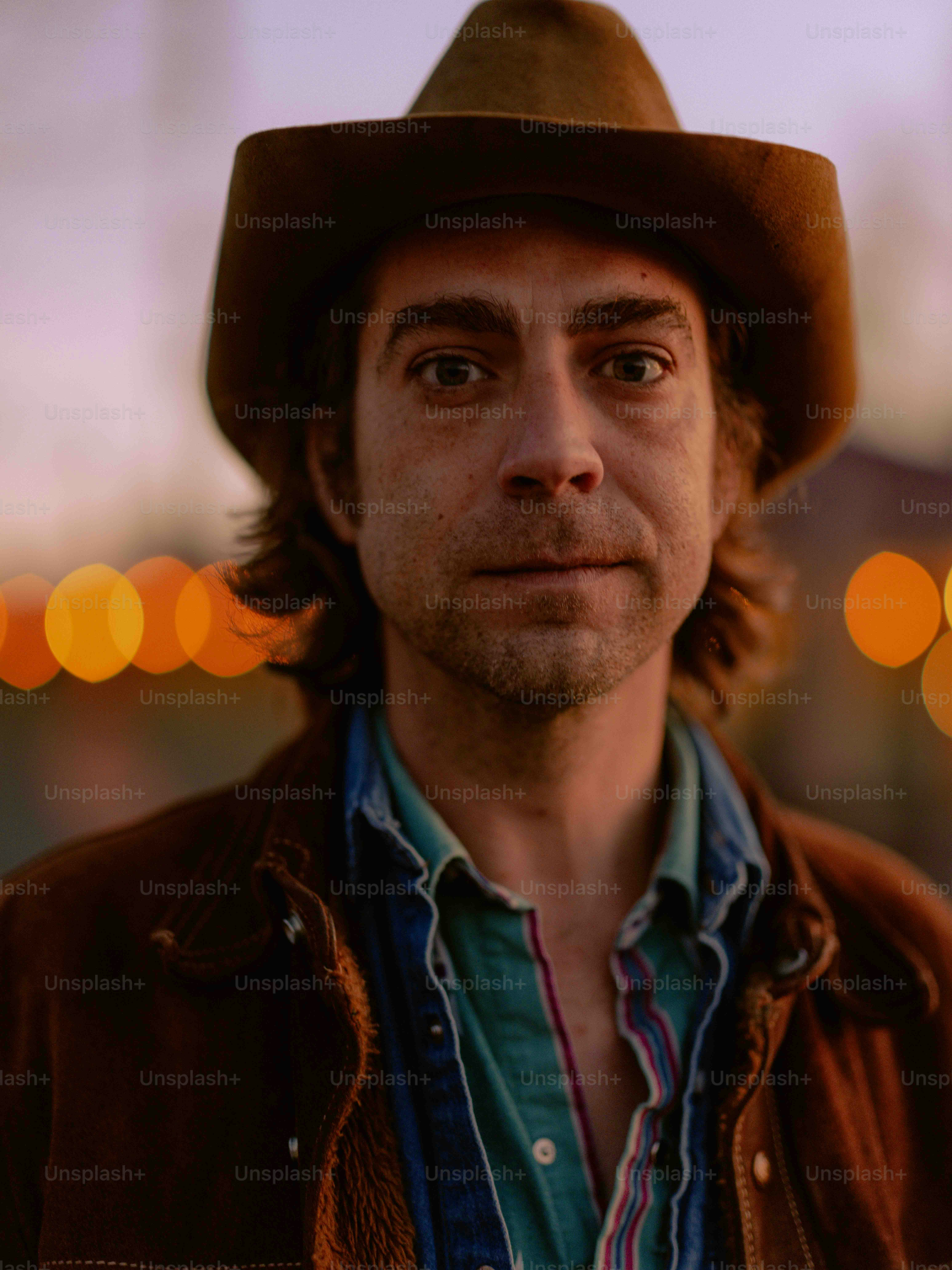 A man wearing a brown hat and jacket