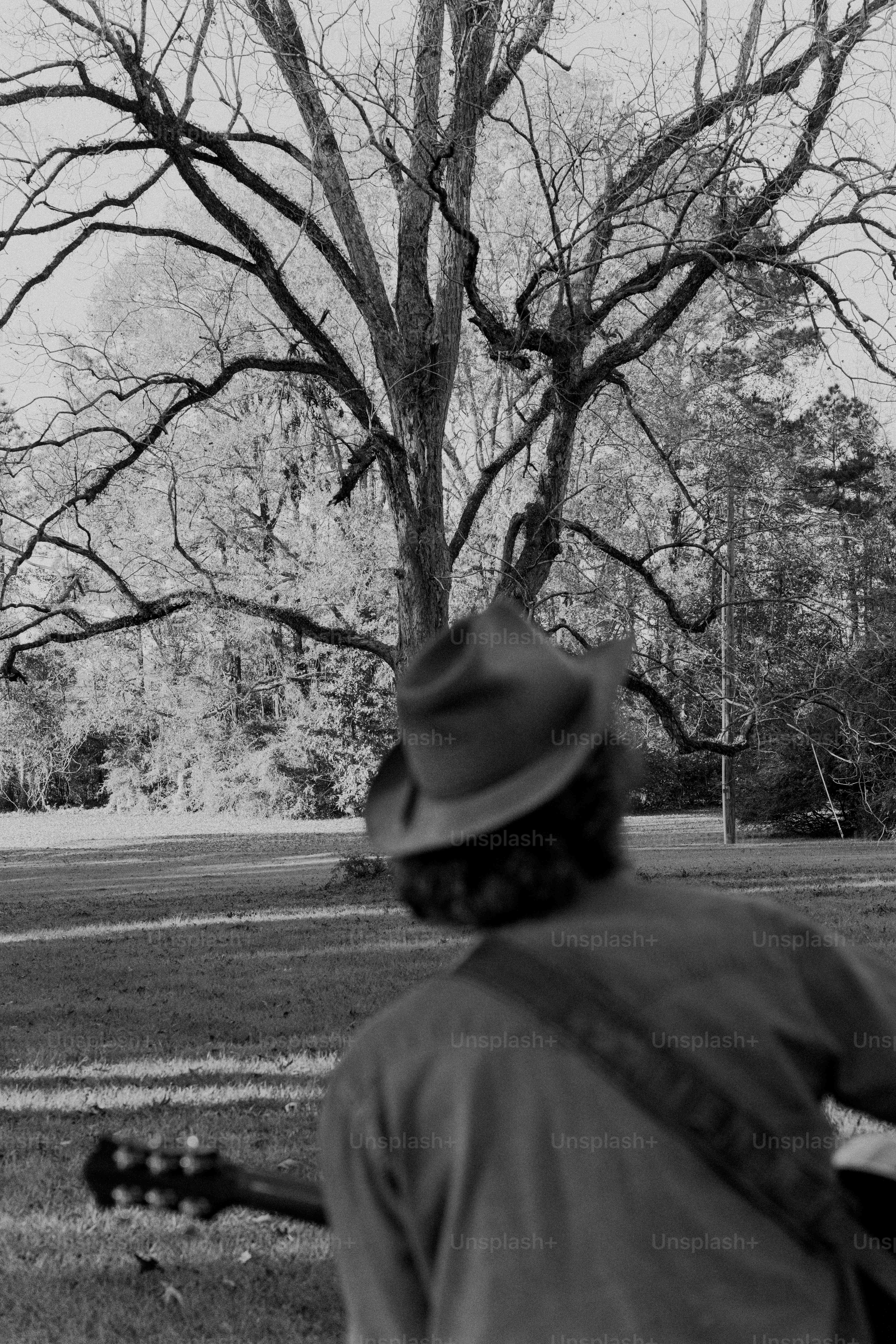 A man playing a guitar in a park