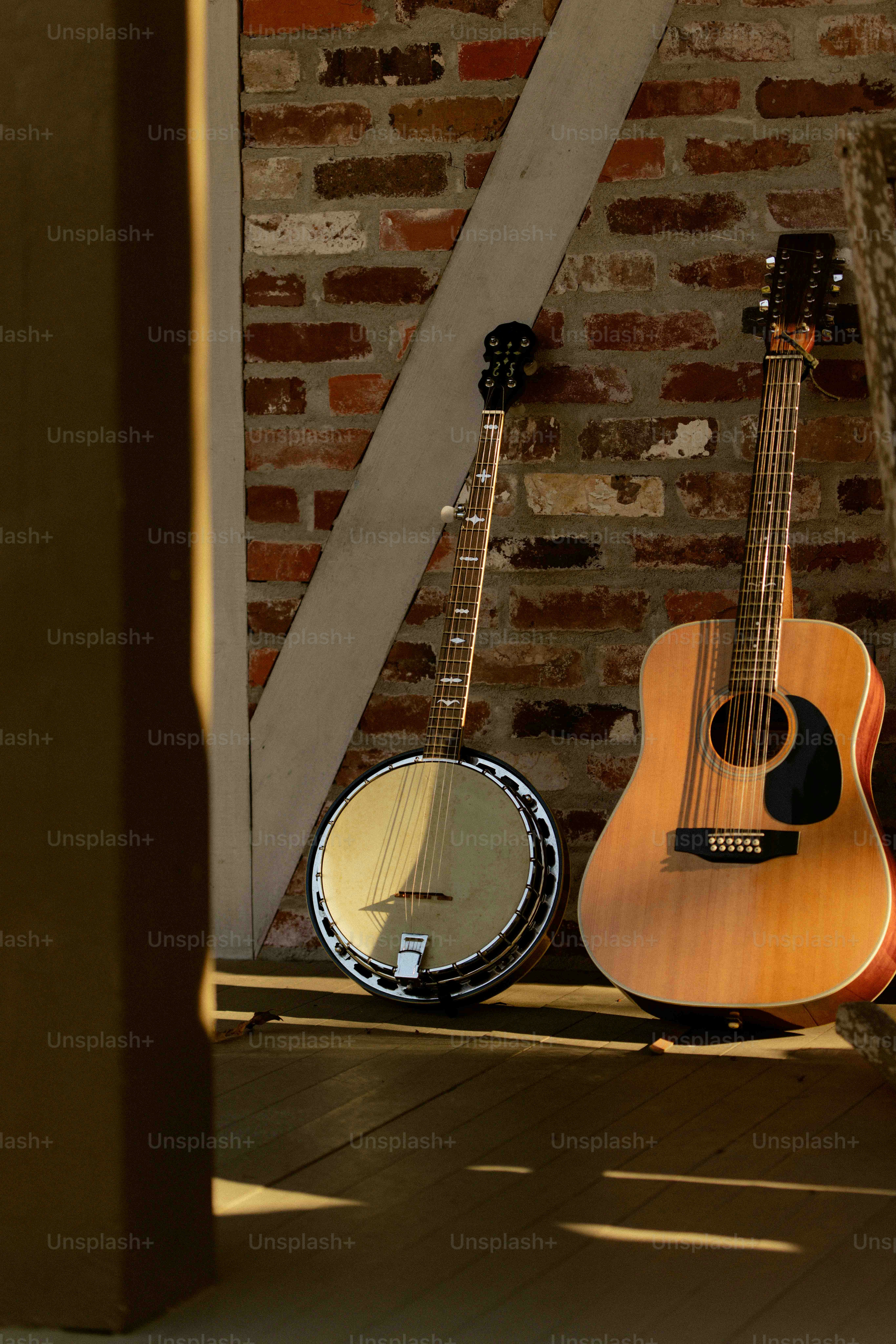 A couple of guitars sitting on top of a hard wood floor