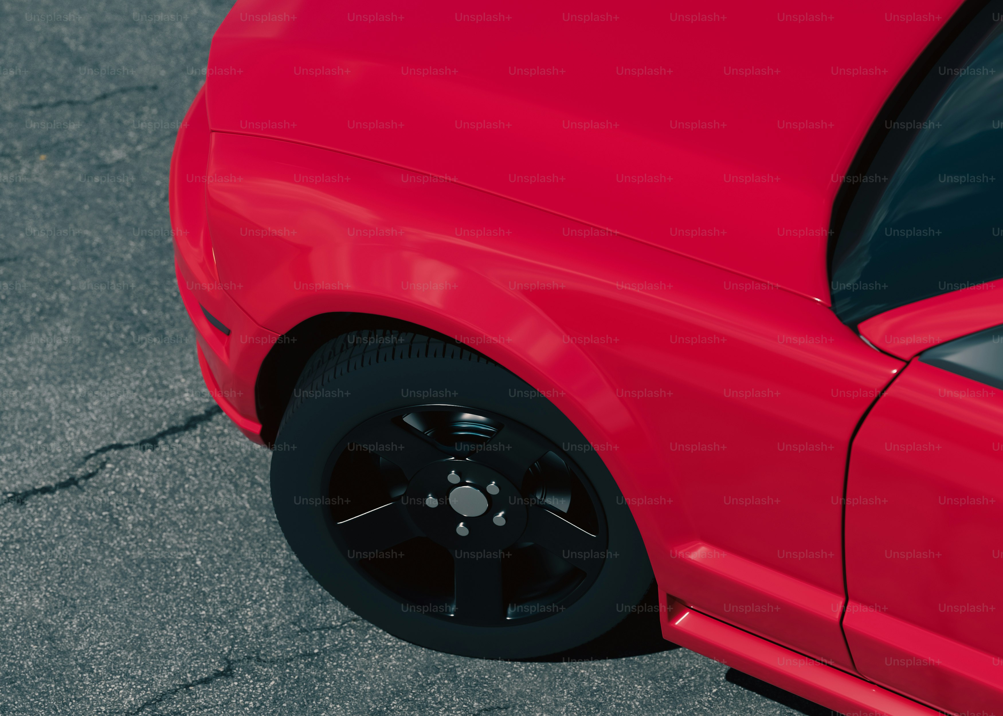 A close up of a red car parked on the street