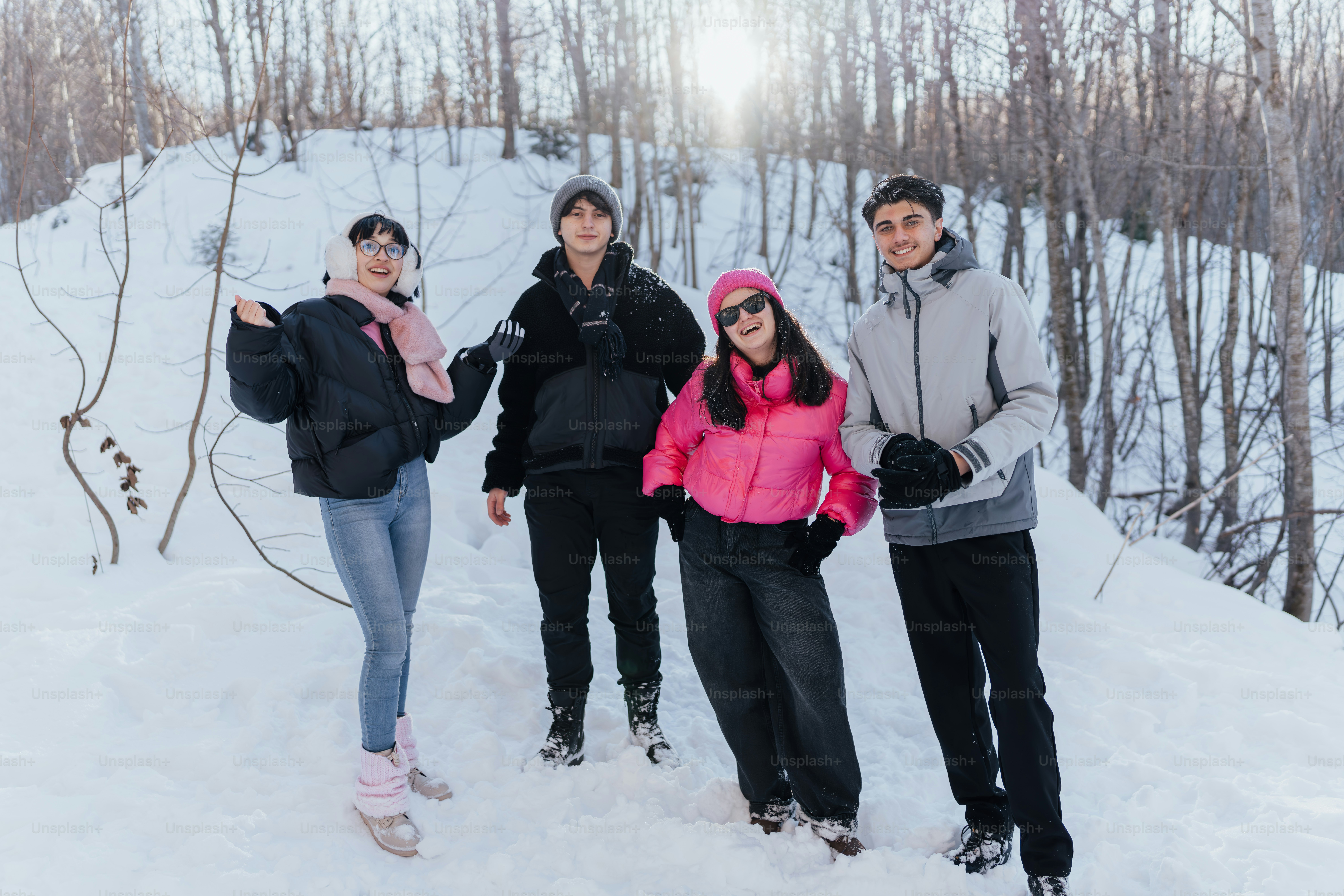 A group of people standing on top of a snow covered slope