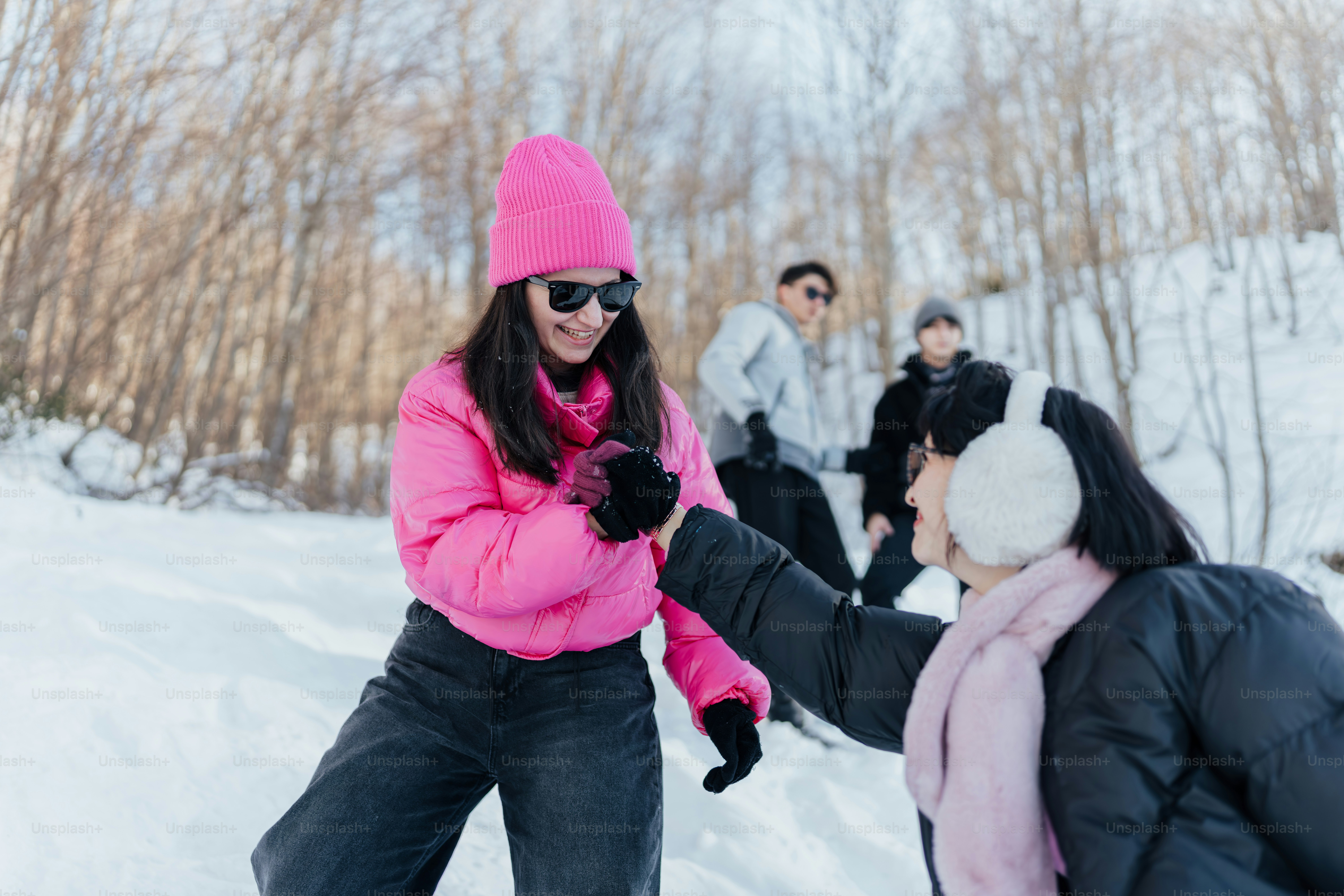 A woman in a pink coat and hat on skis