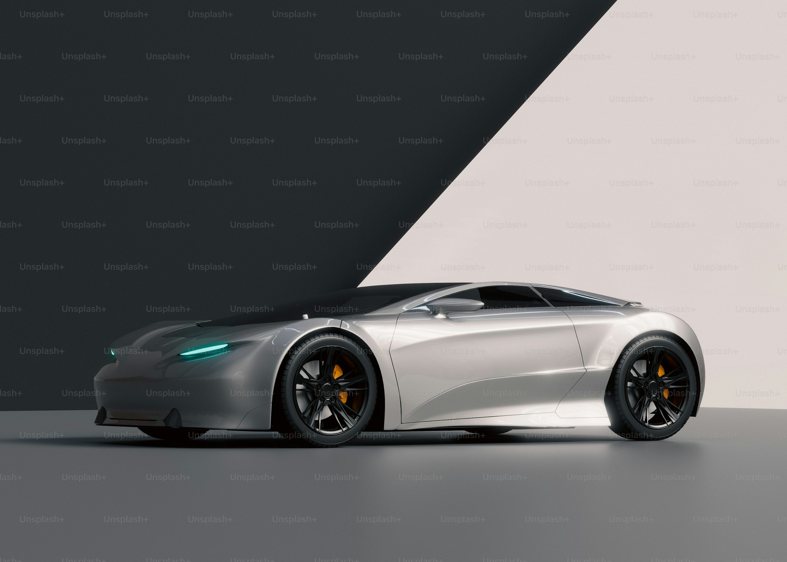 A silver sports car parked in front of a black and white wall