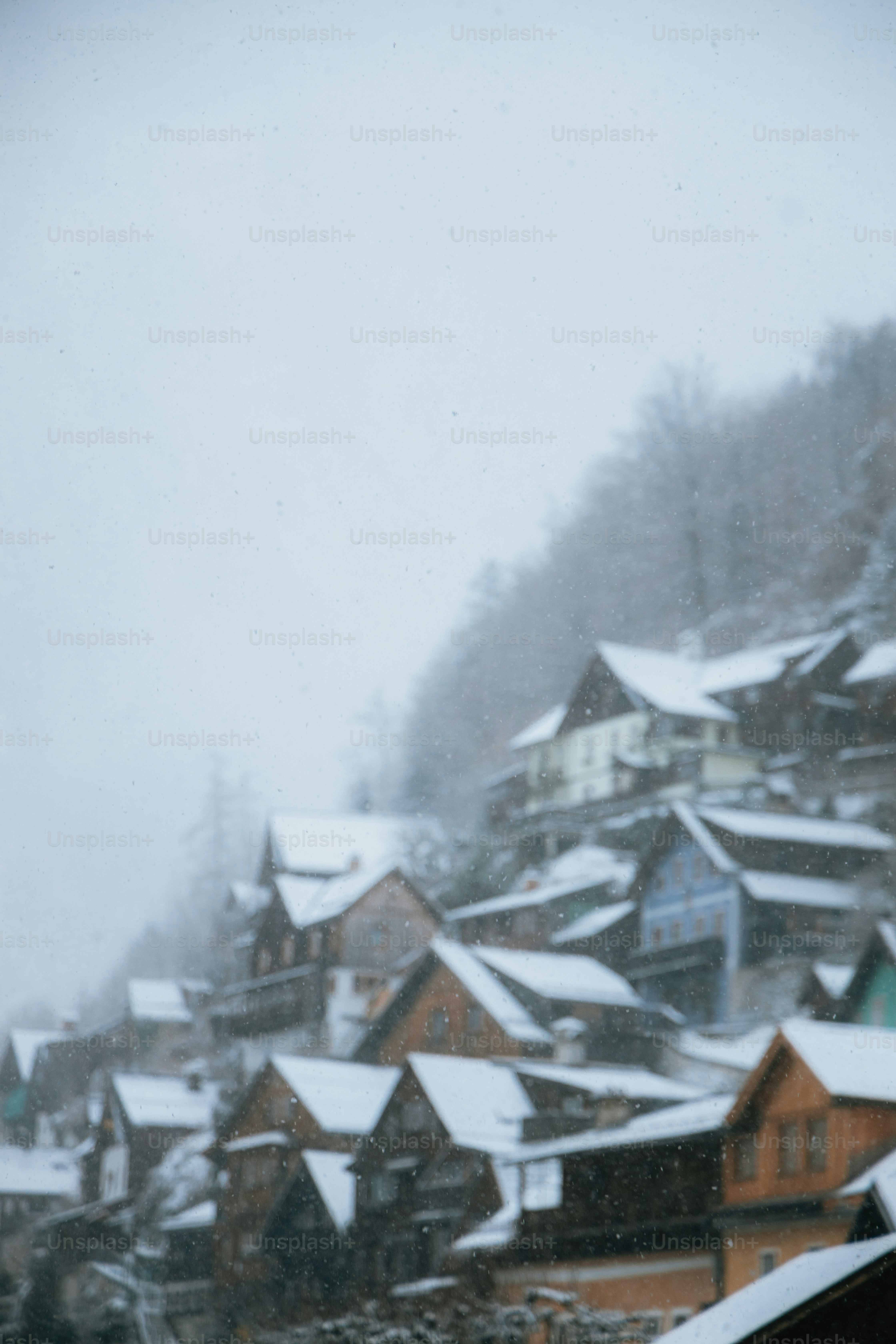 A snow covered village with a clock tower in the foreground