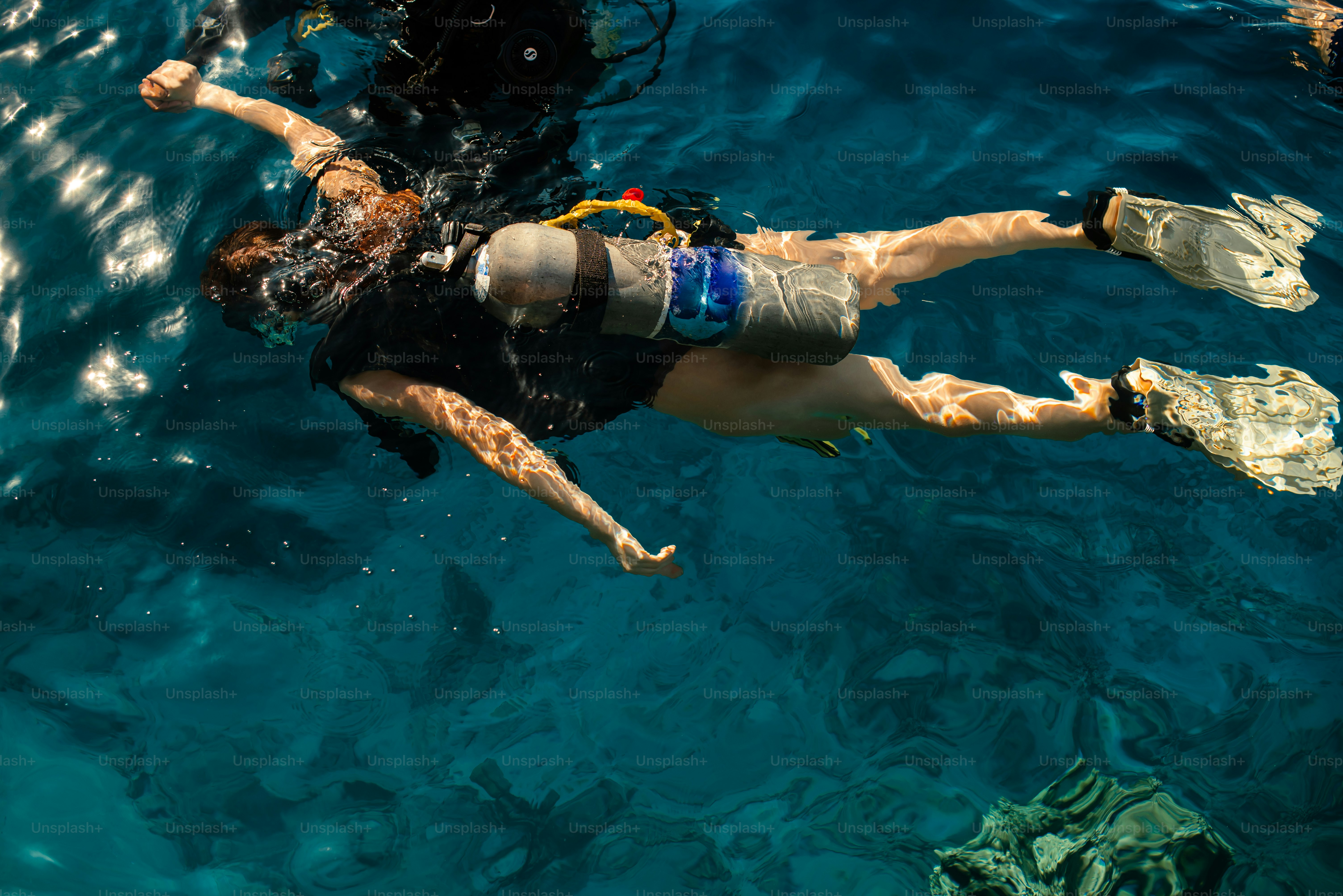 A man and a woman swimming in the ocean