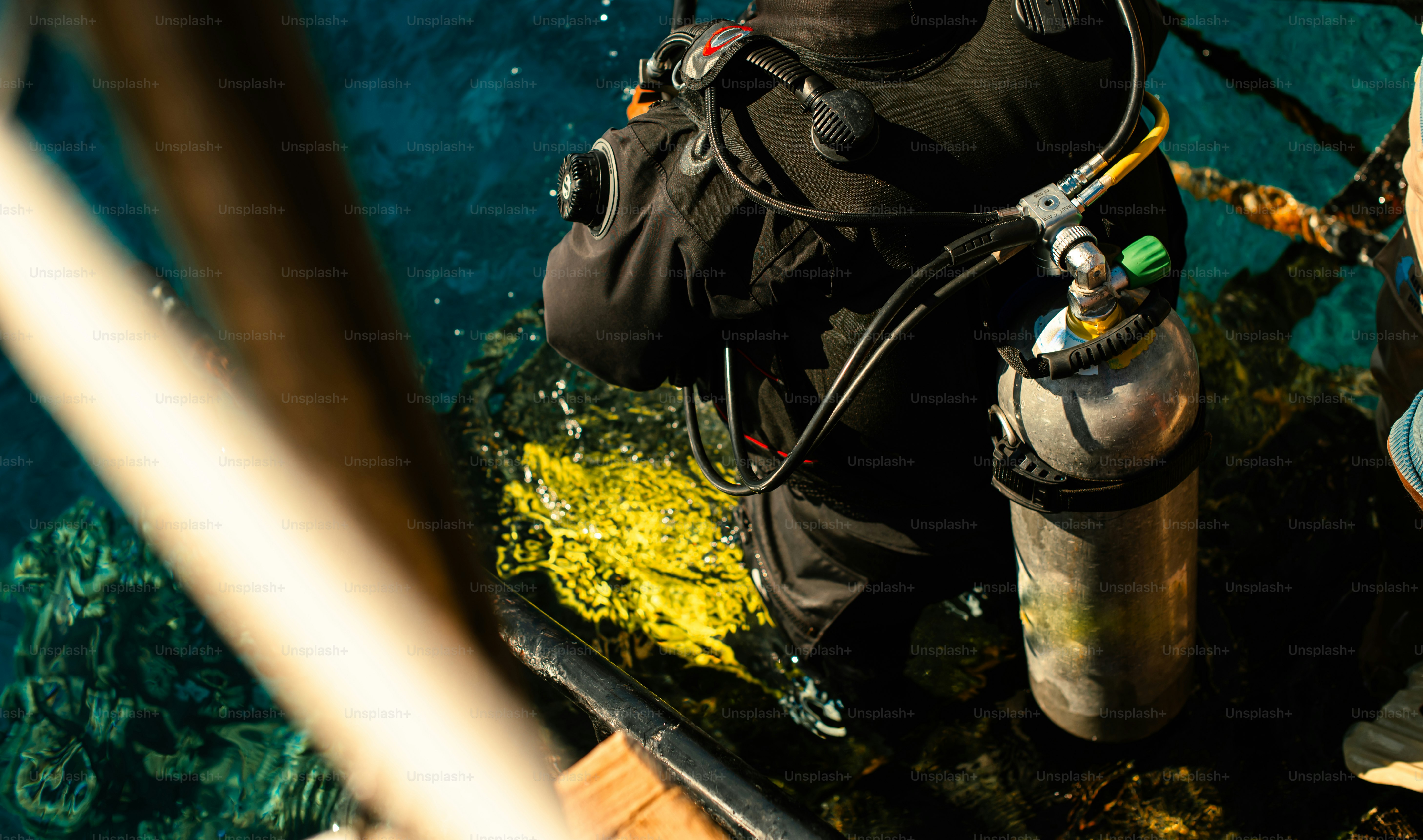 A man in a diving suit standing next to a fire hydrant