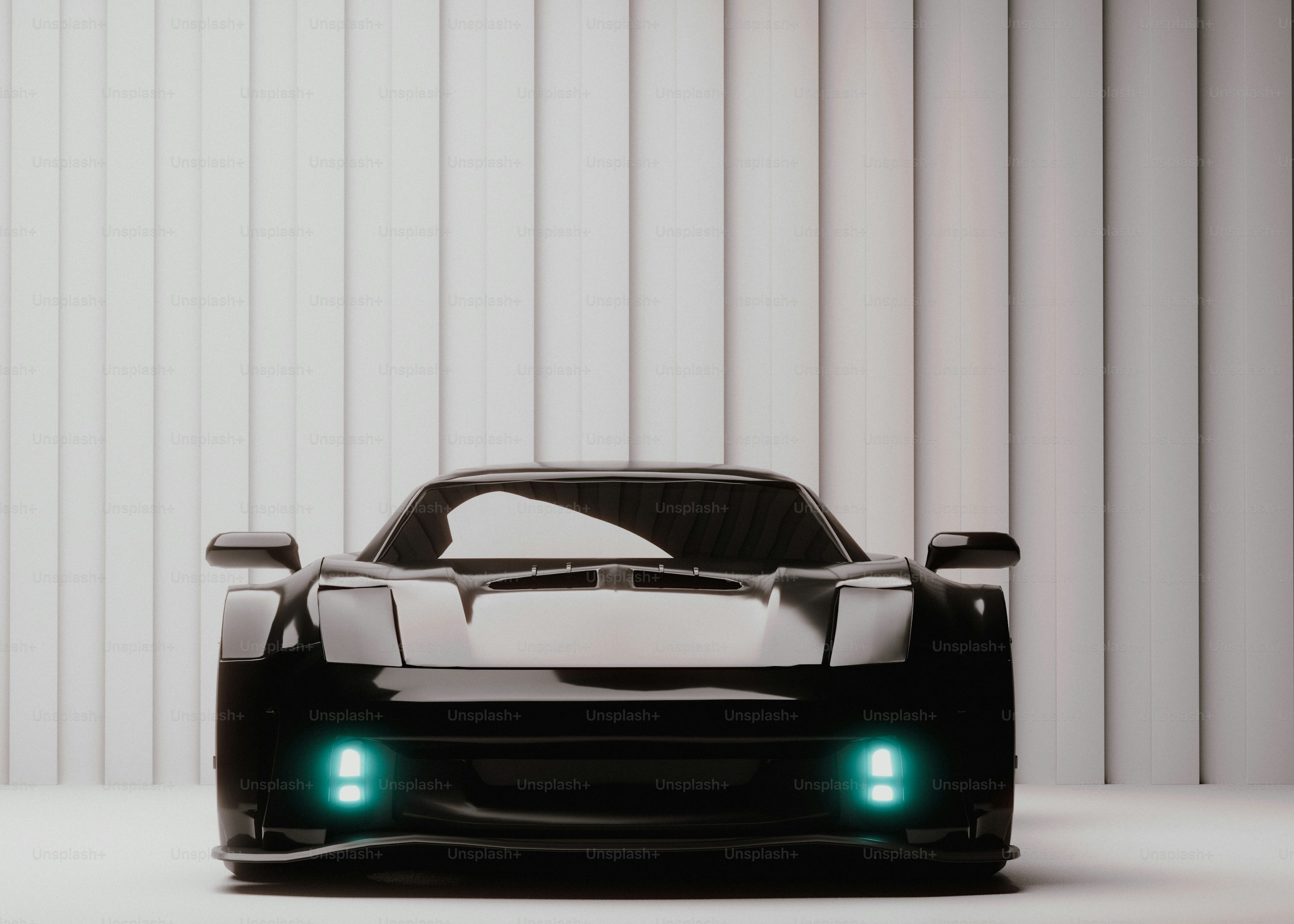 A black sports car with its lights on
