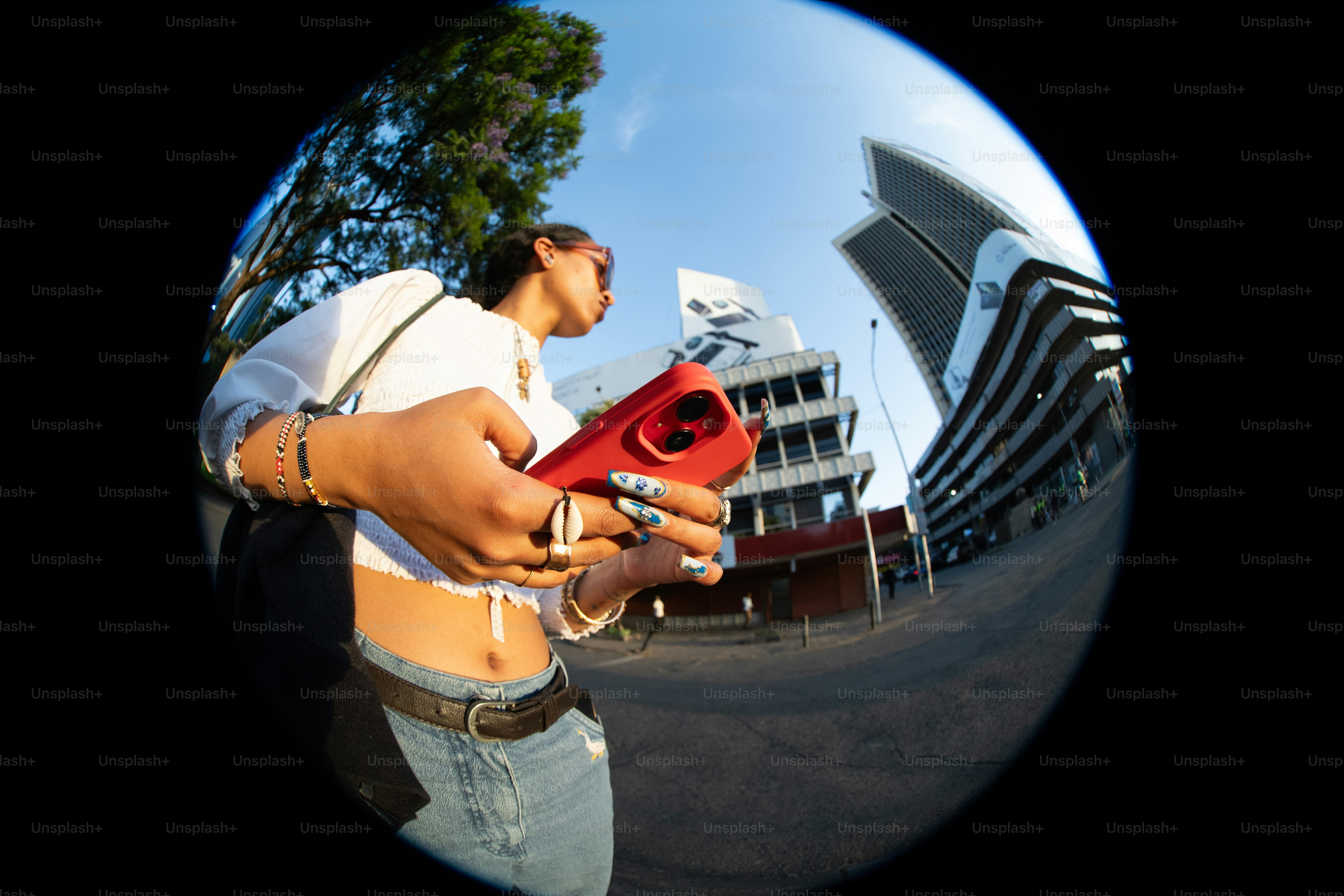 A man holding a red blow dryer in his right hand