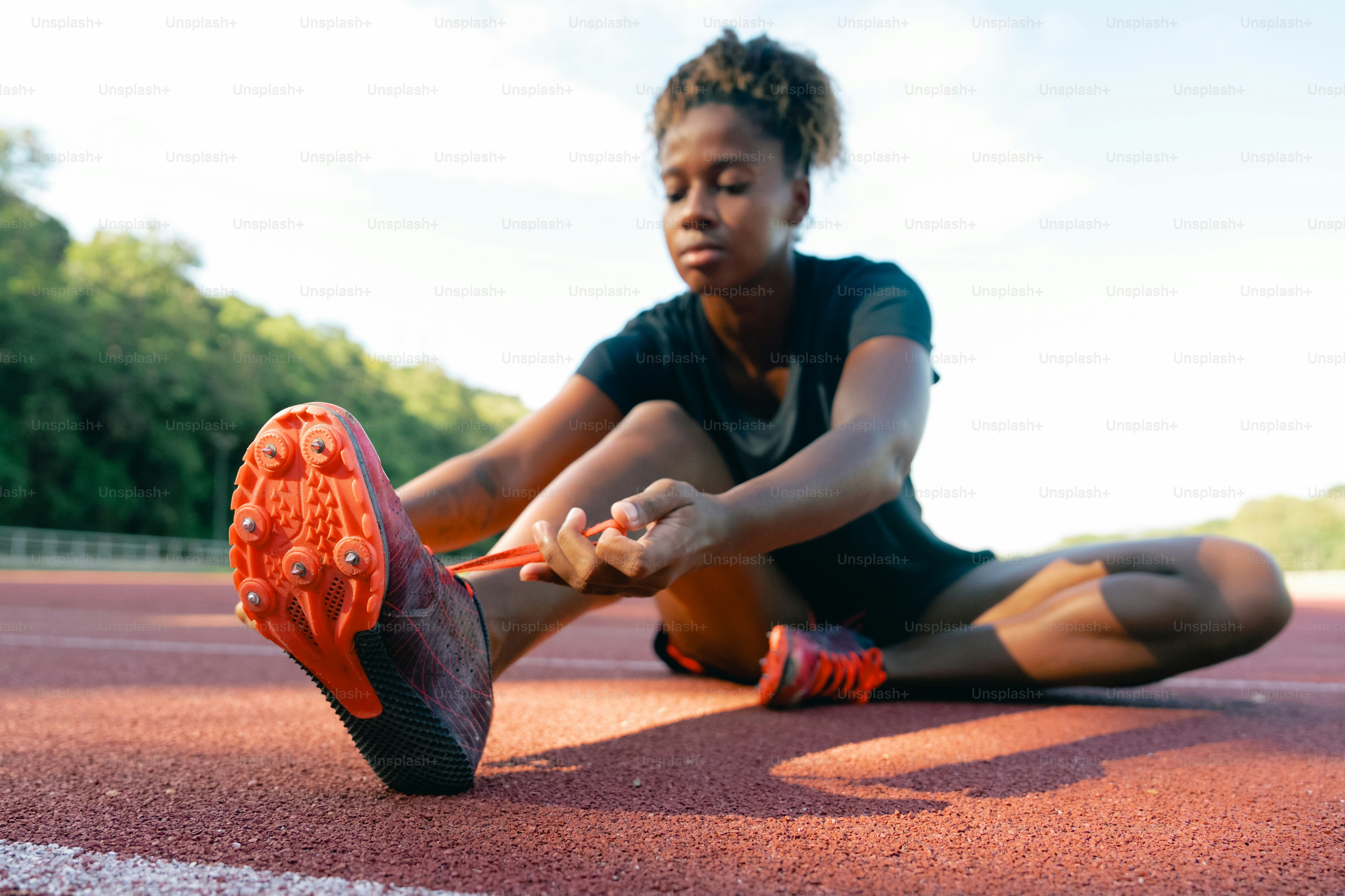 A woman is sitting on a running track