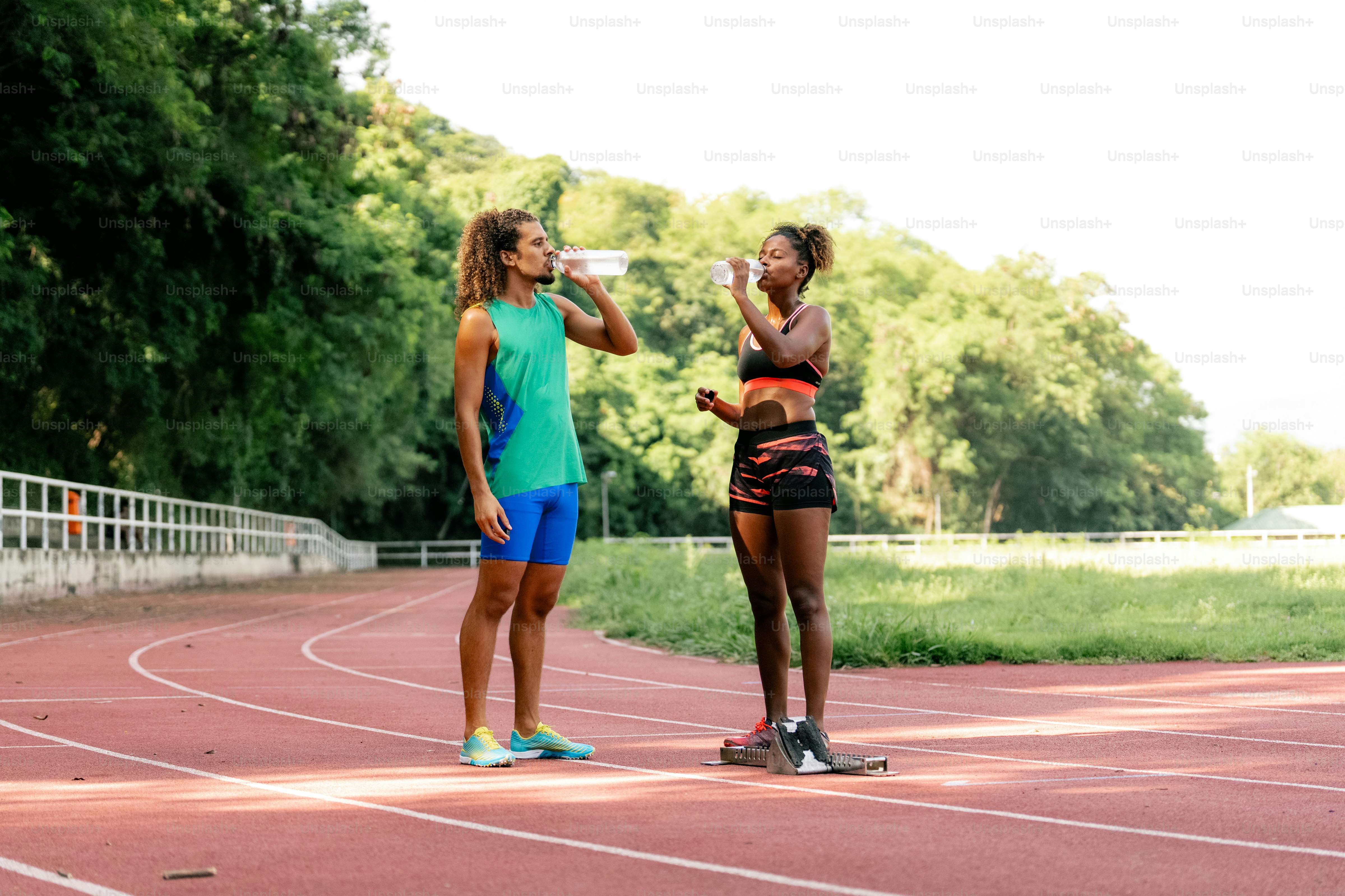 A couple of women standing on top of a track
