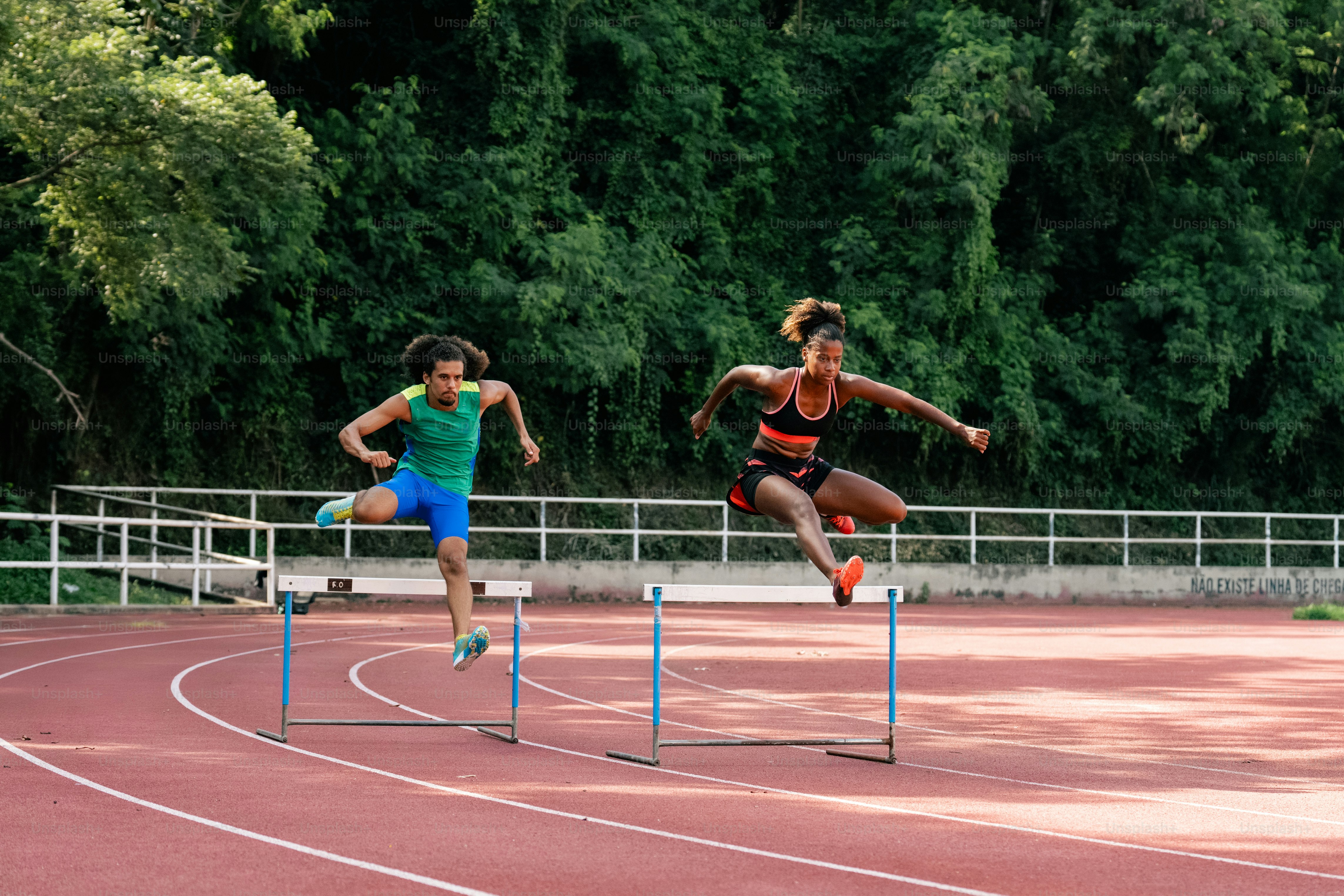 A couple of people that are running on a track photo – Running Image on ...