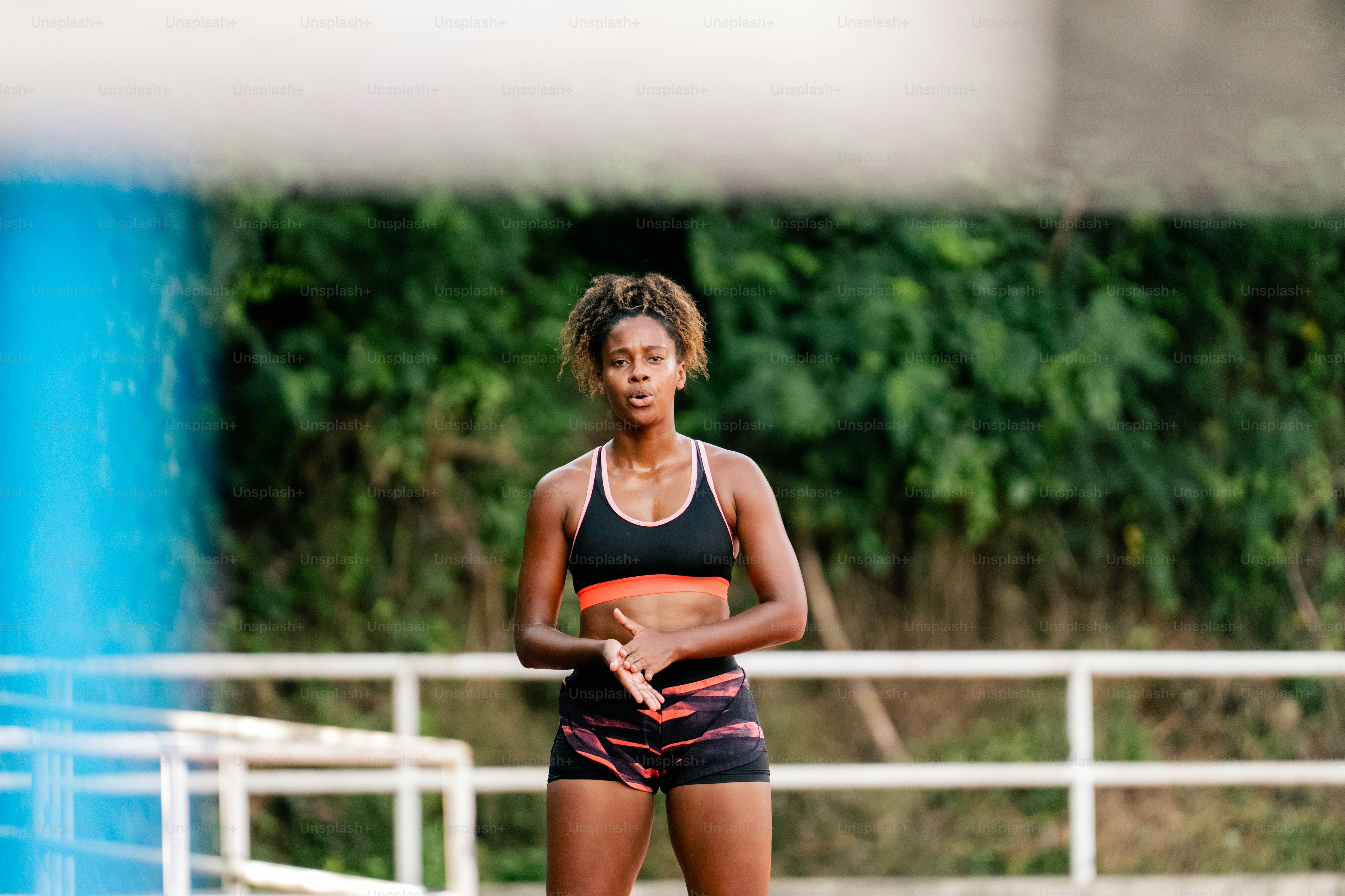 A woman standing on a tennis court holding a tennis racquet