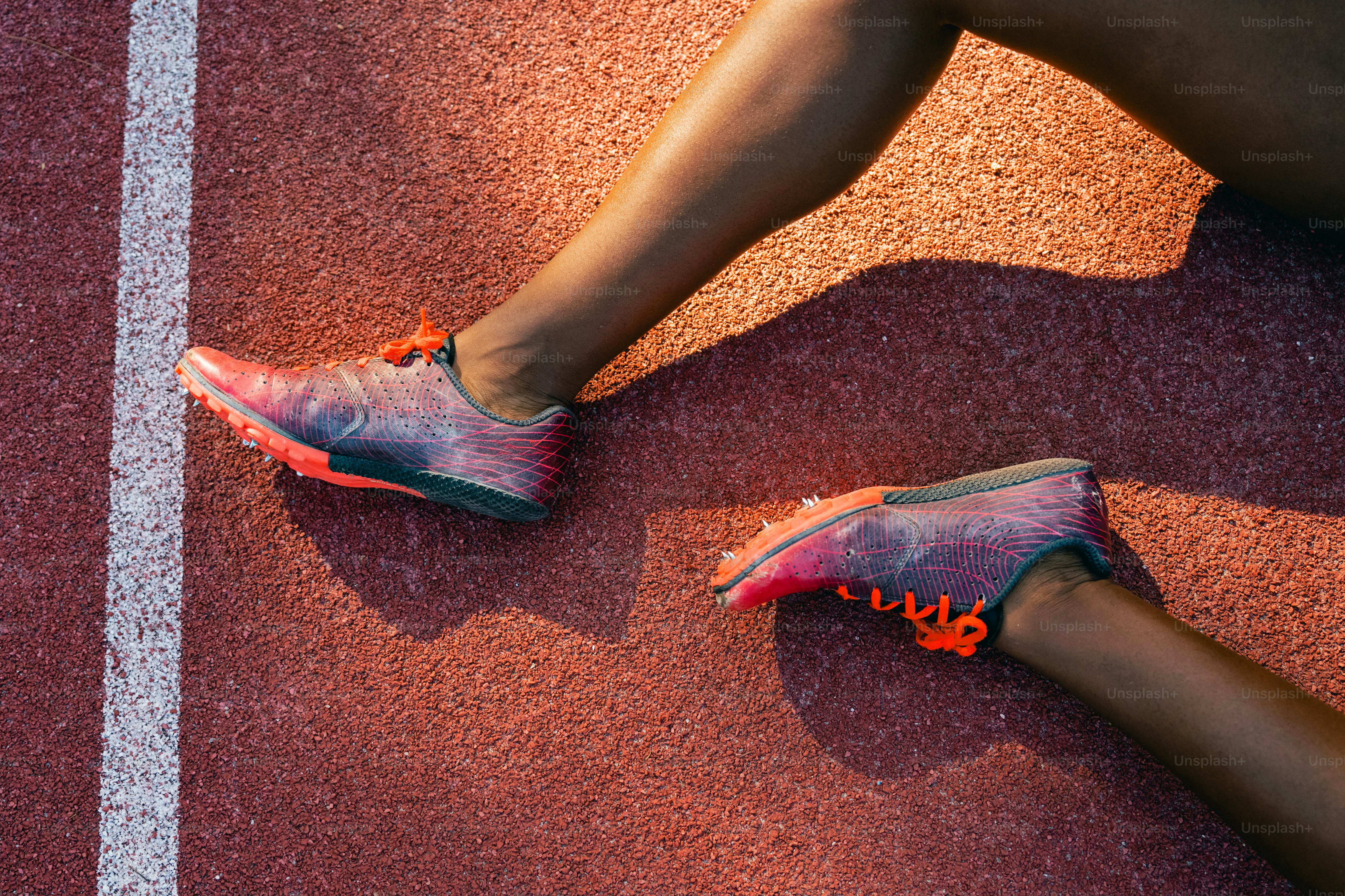 A close up of a person's feet on a running track