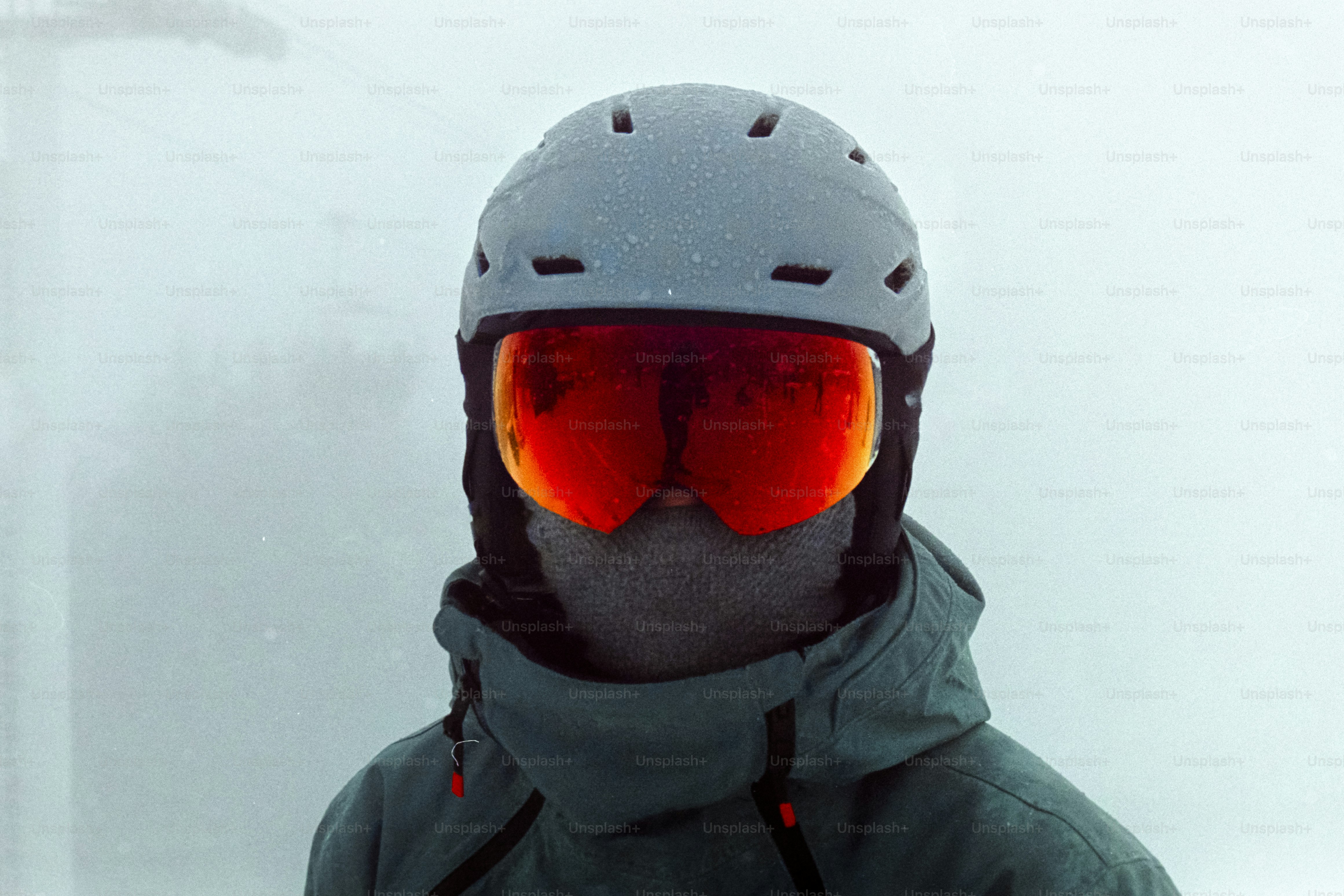 A person wearing a helmet and goggles in the snow