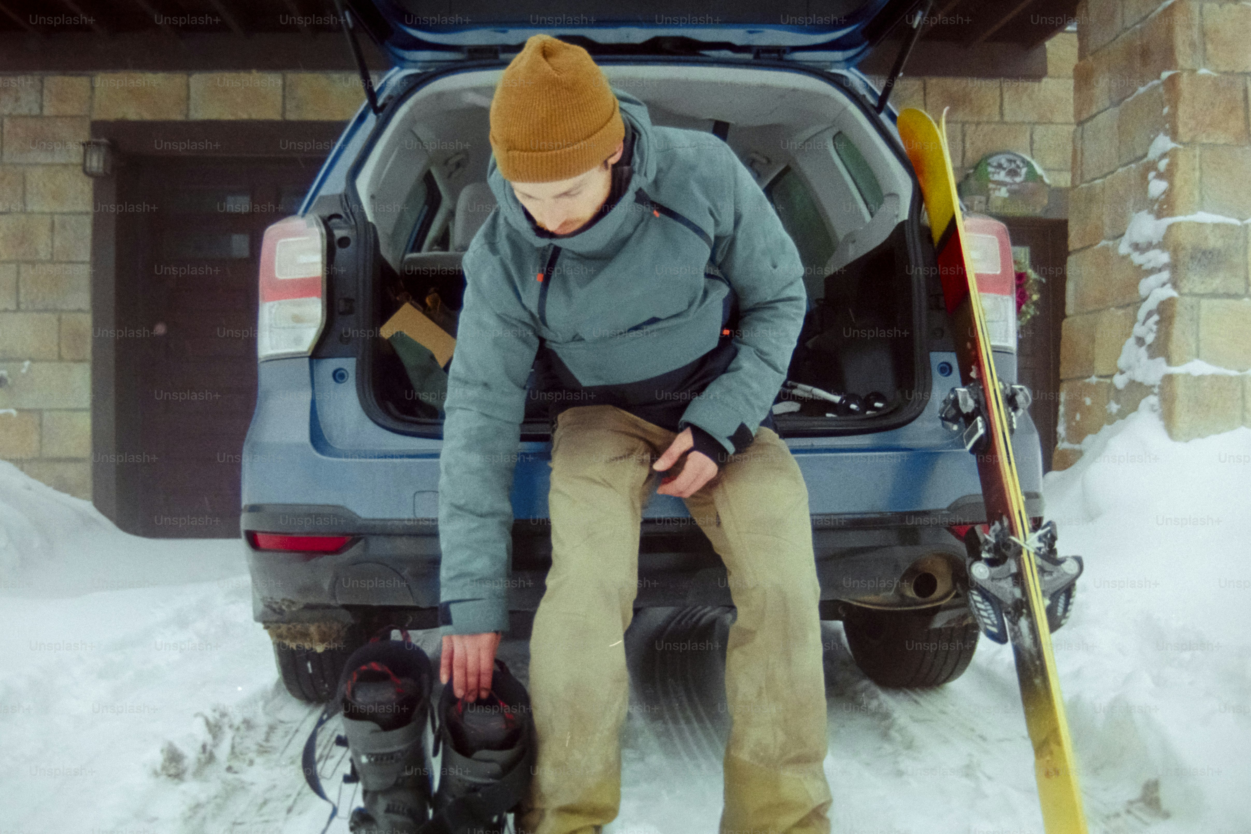 A man sitting in the back of a car in the snow