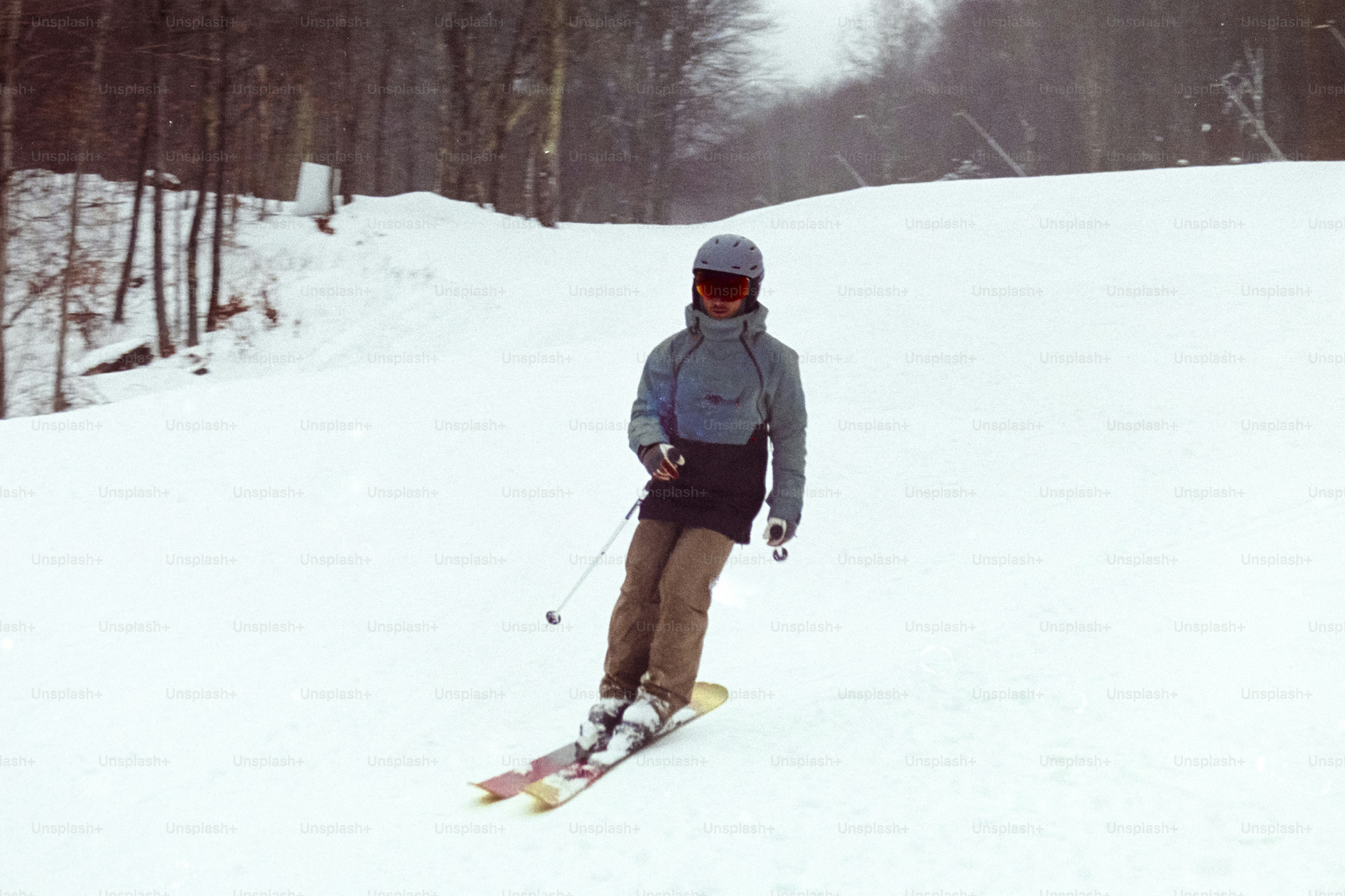 A man riding skis down a snow covered slope