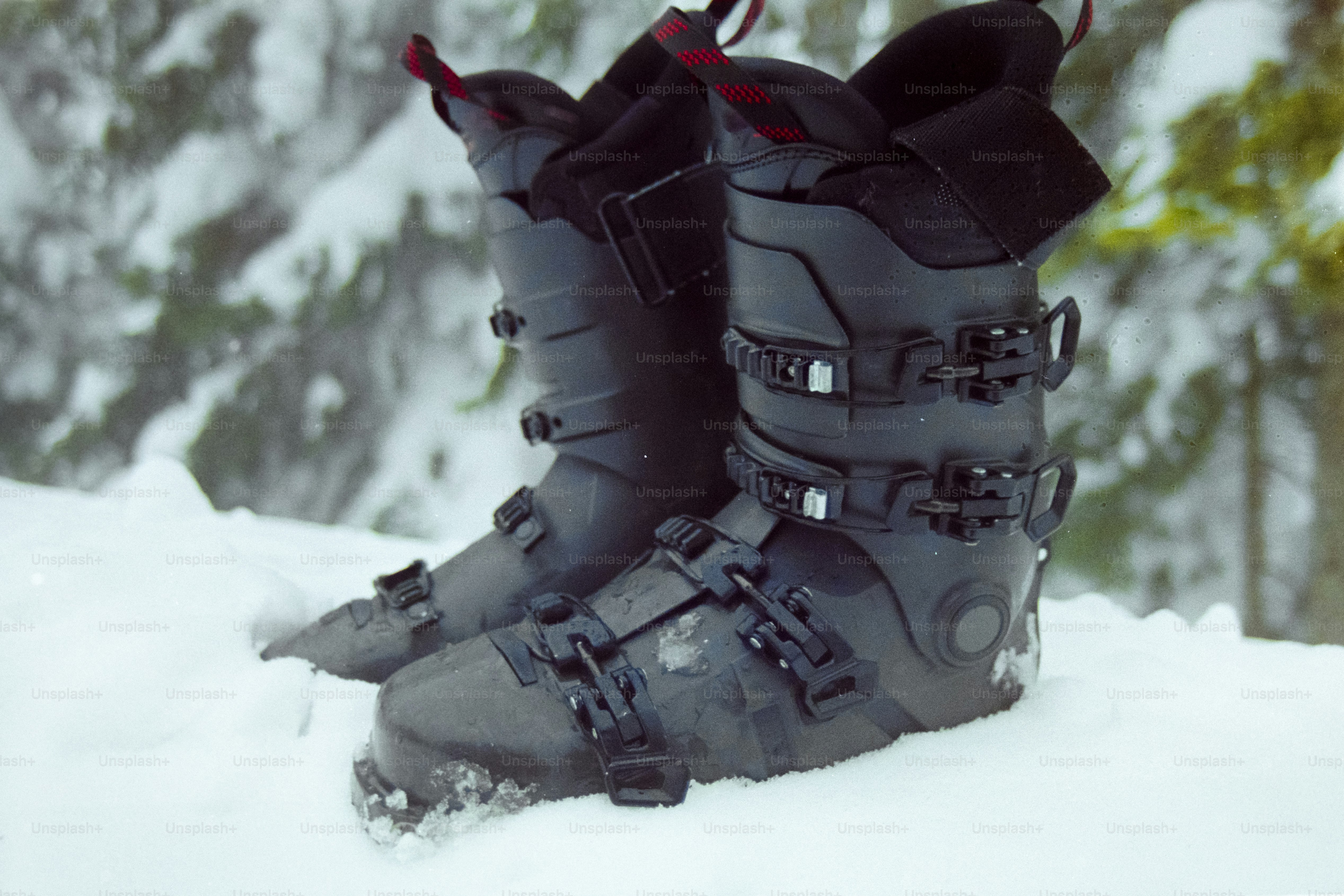 A pair of ski boots sitting in the snow