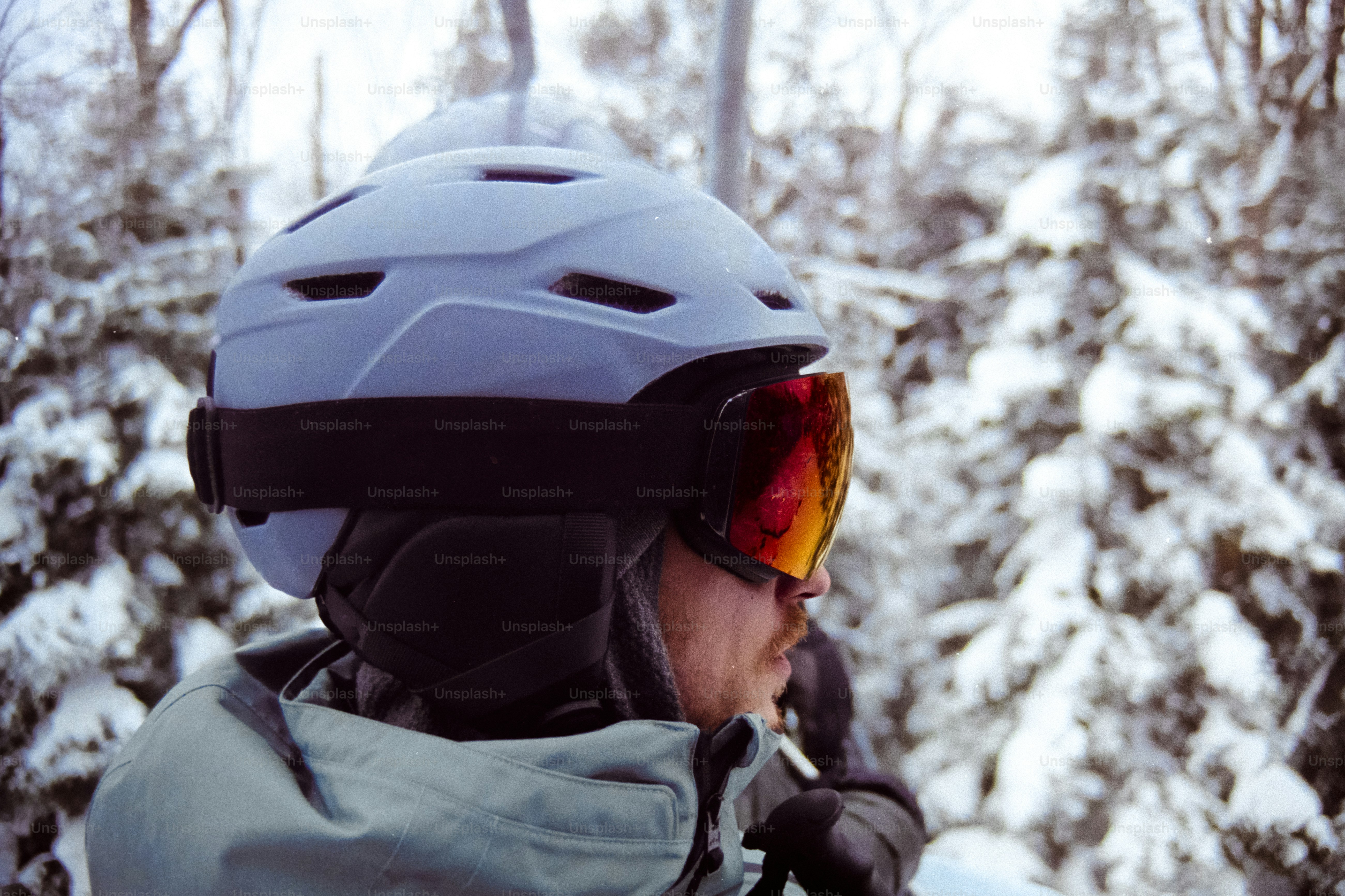 A person wearing a helmet and goggles in the snow