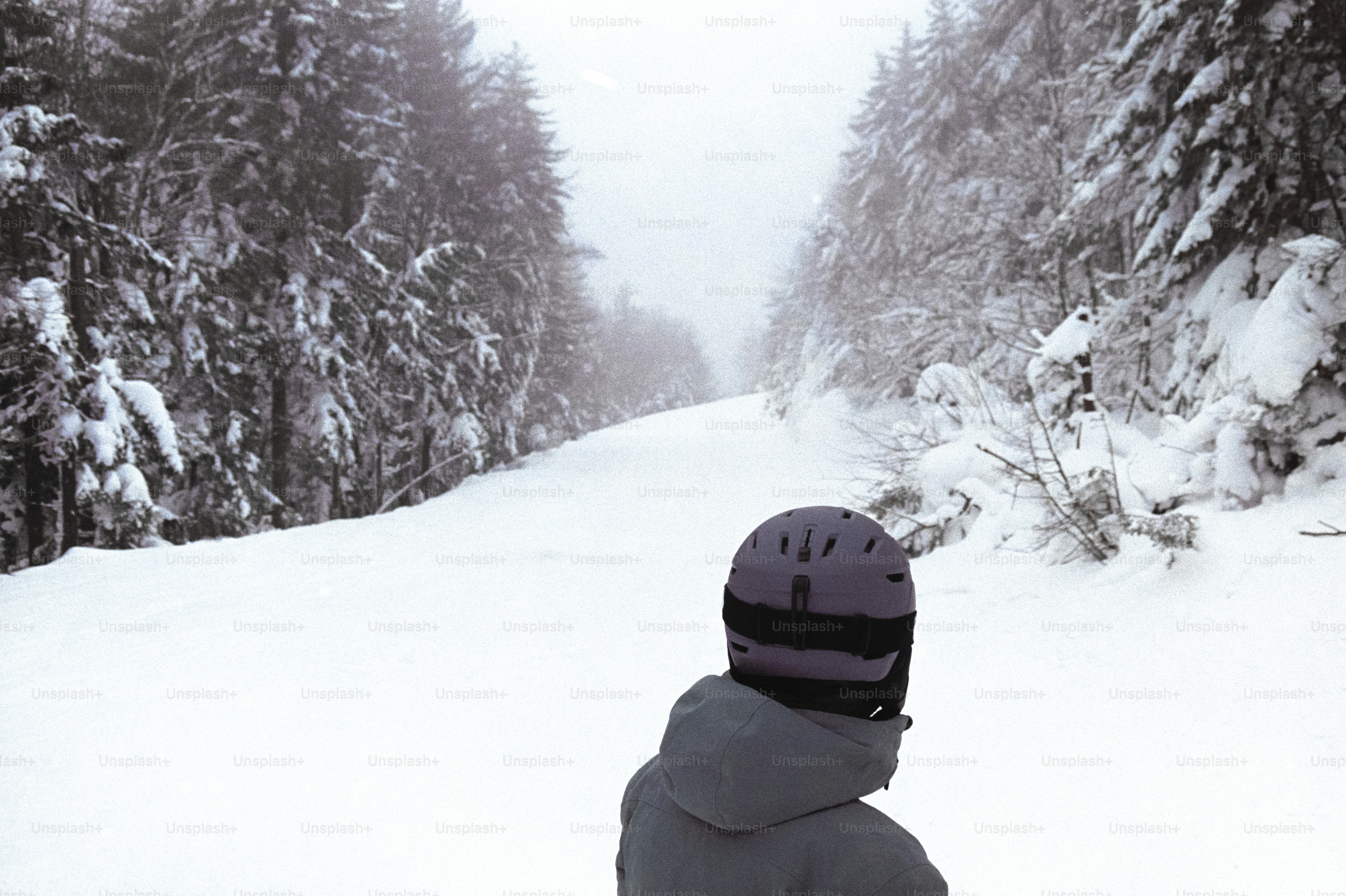A person riding skis down a snow covered slope