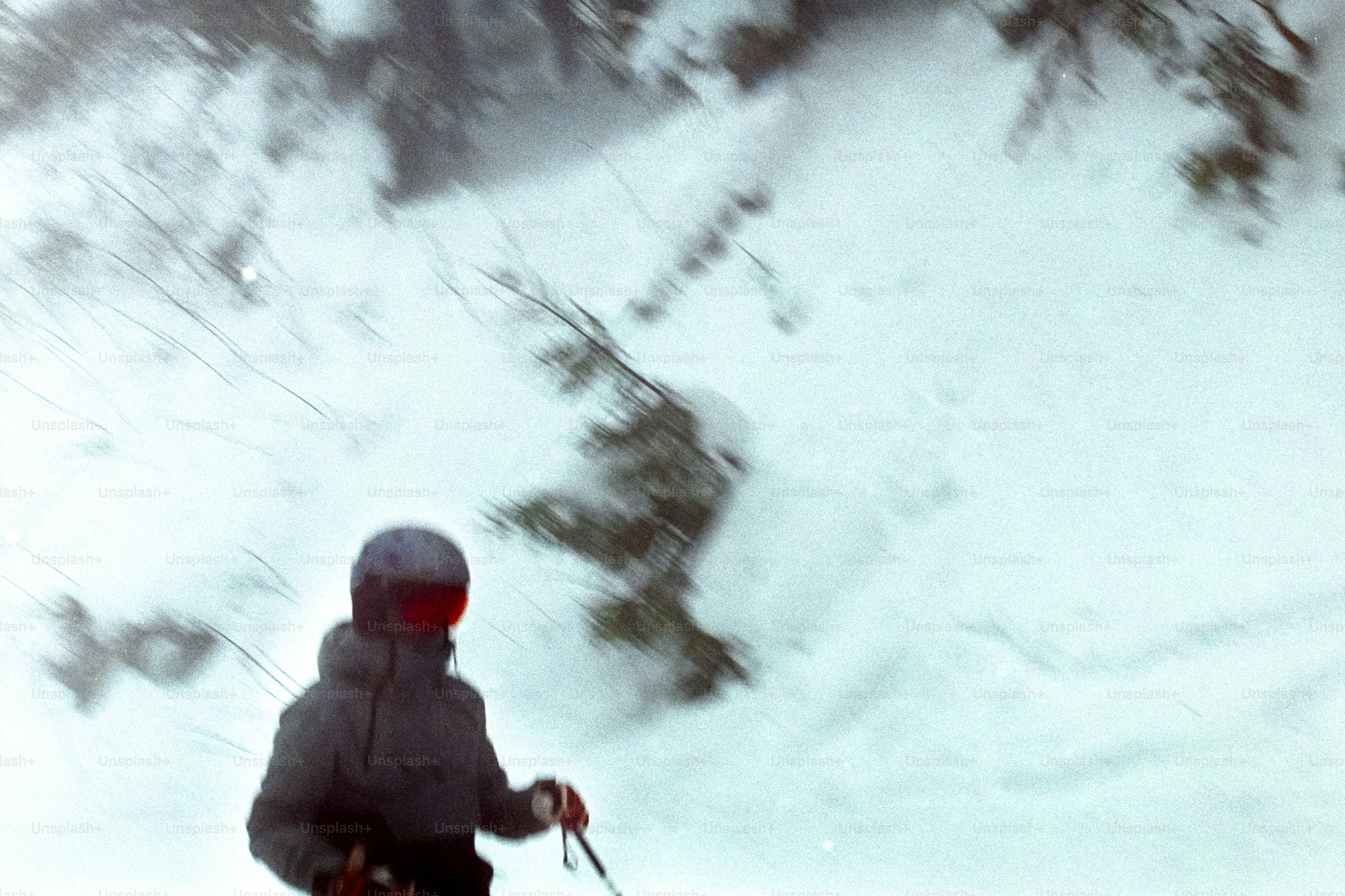 A man riding skis down a snow covered slope