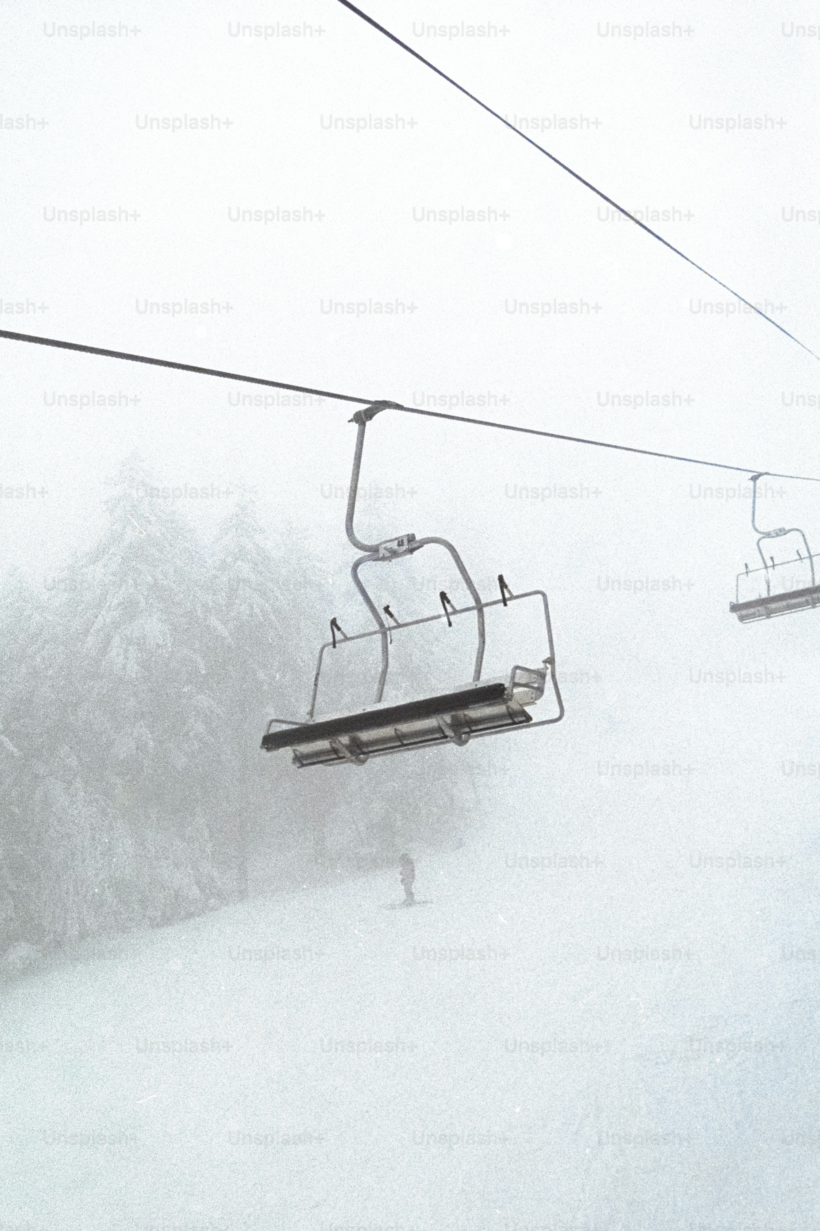 A ski lift going up a snowy mountain
