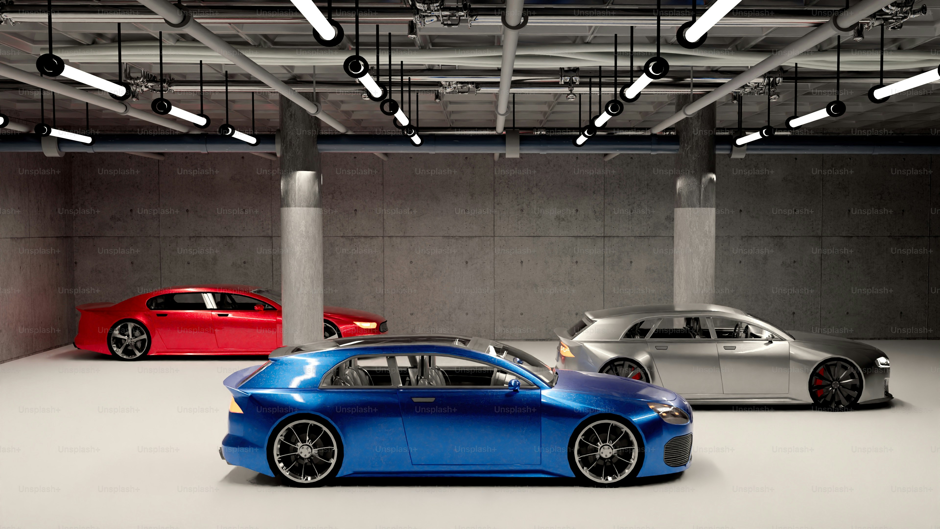 Three different colored cars parked in a garage