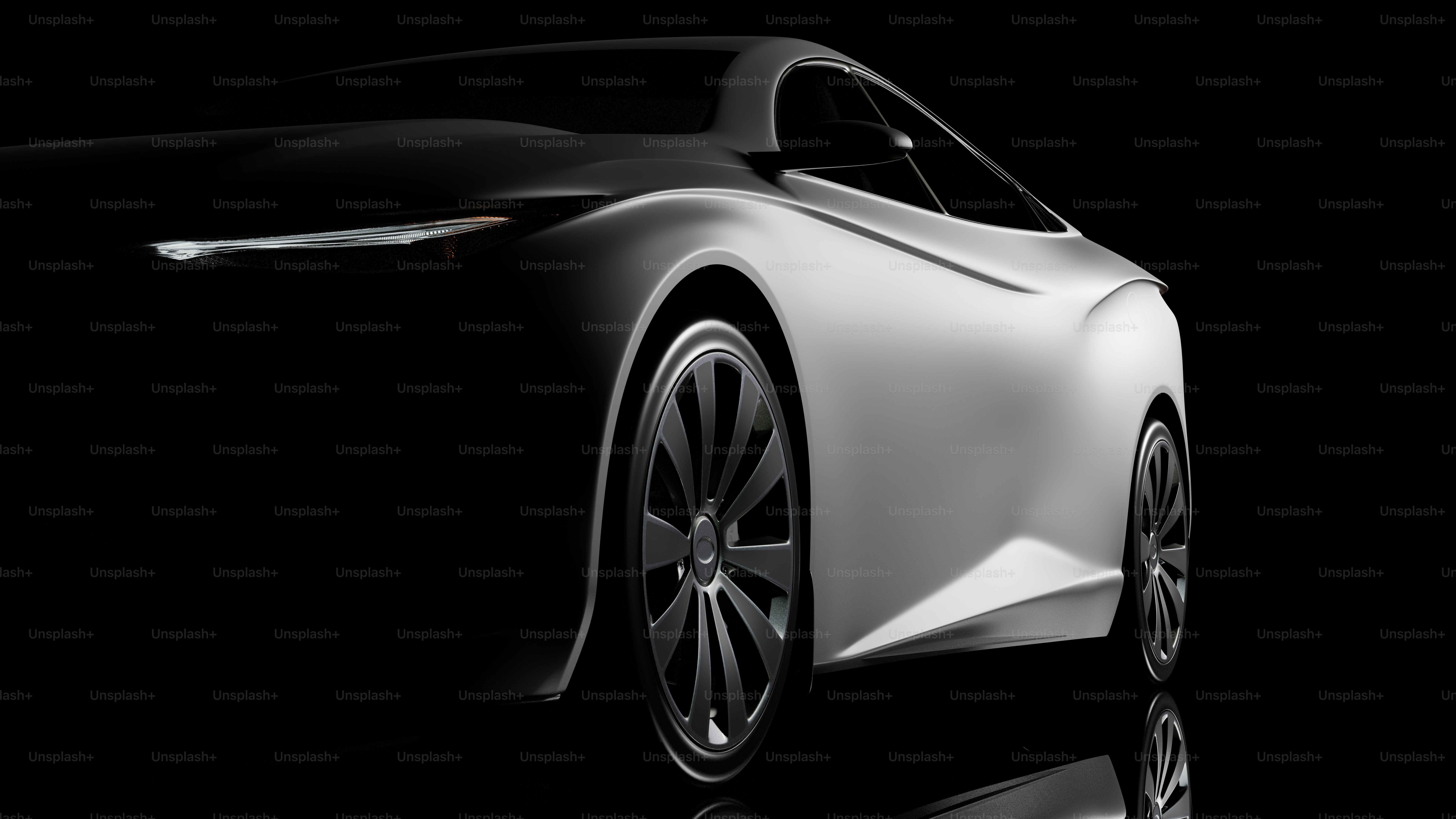 A white car is shown in a black background