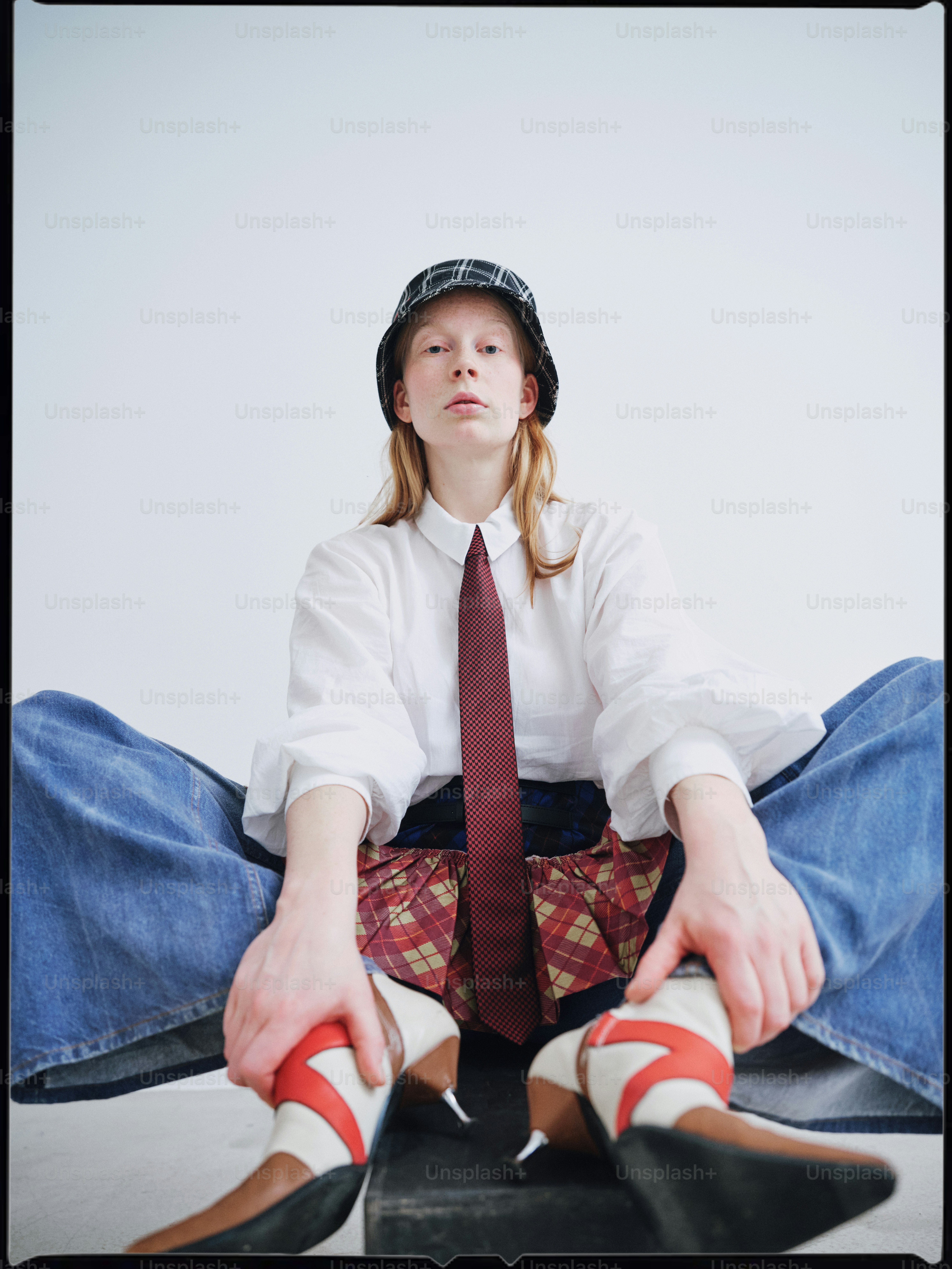 A woman sitting on the ground with her legs crossed