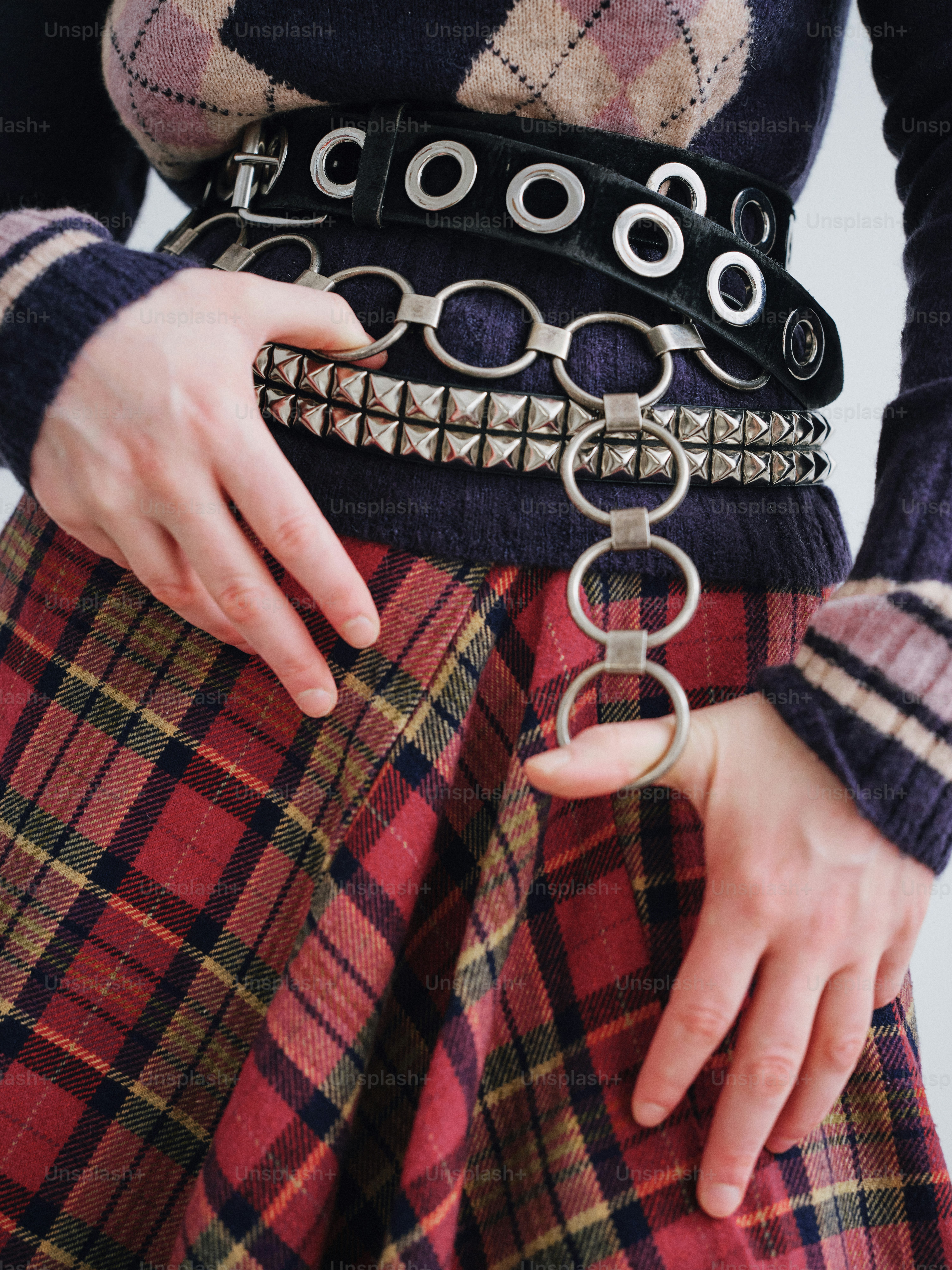 A woman wearing a plaid skirt and a black sweater