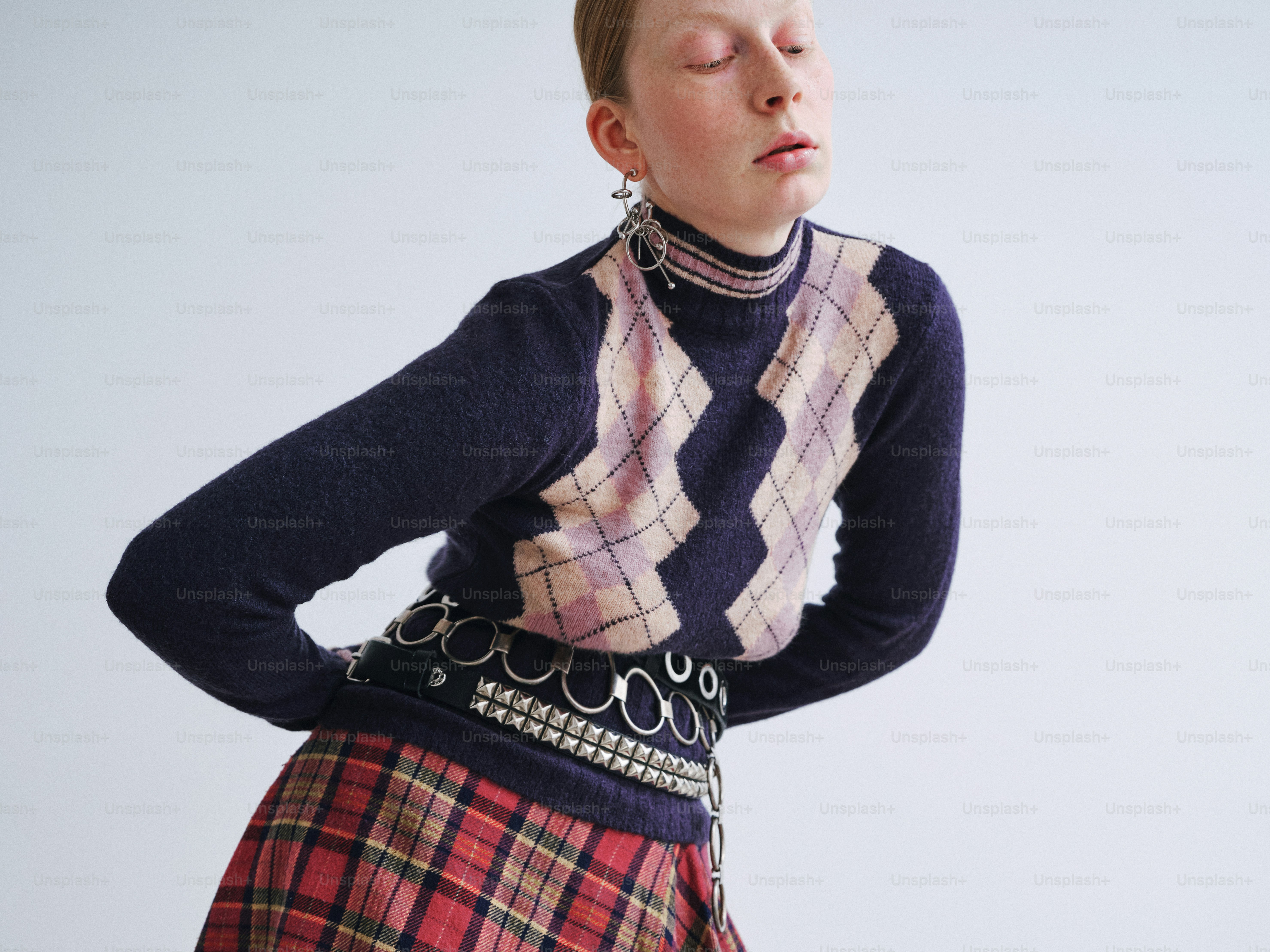 A woman wearing a skirt and a sweater