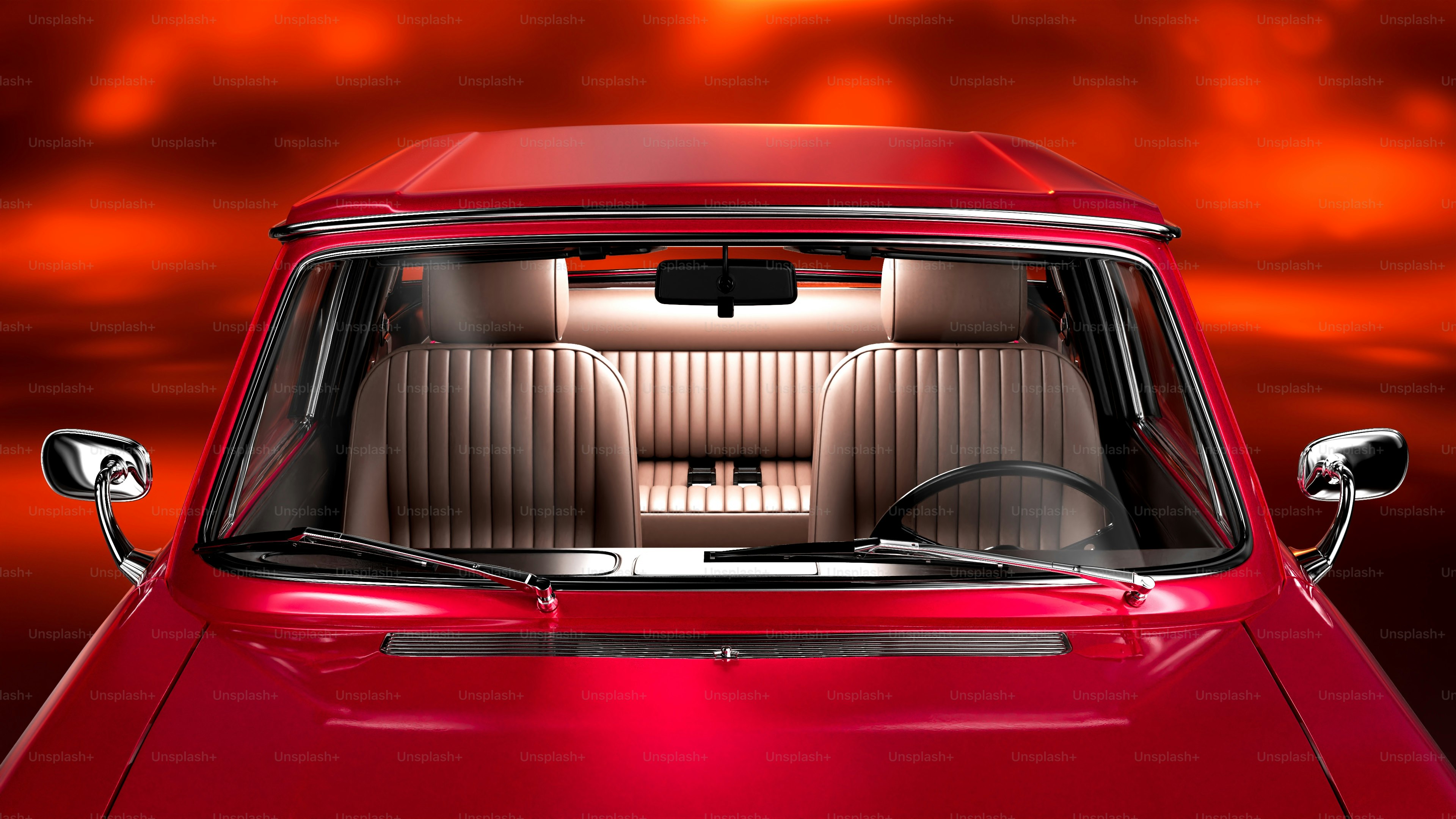 Un'auto rossa con un cielo rosso sullo sfondo