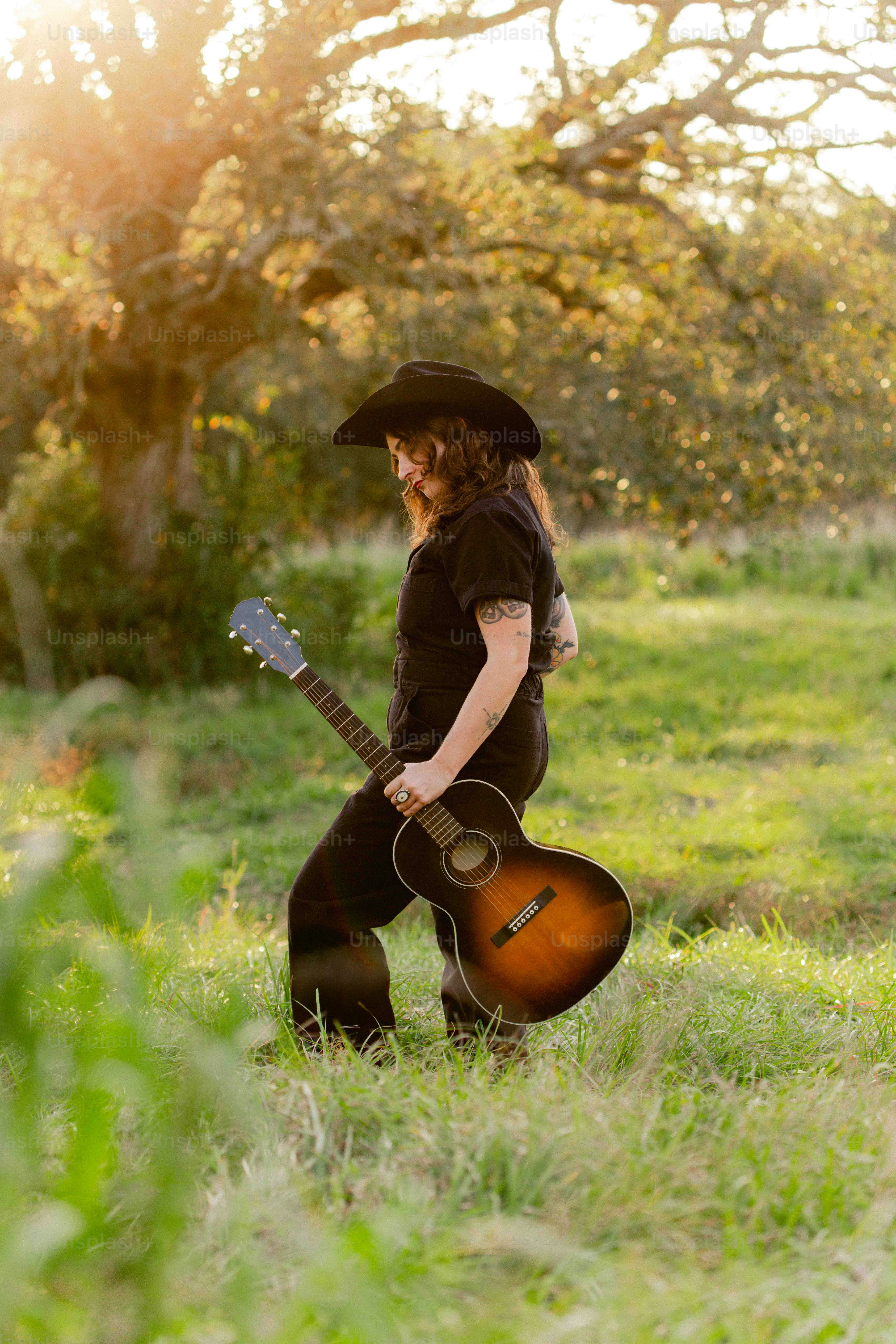 A person with a guitar in a field
