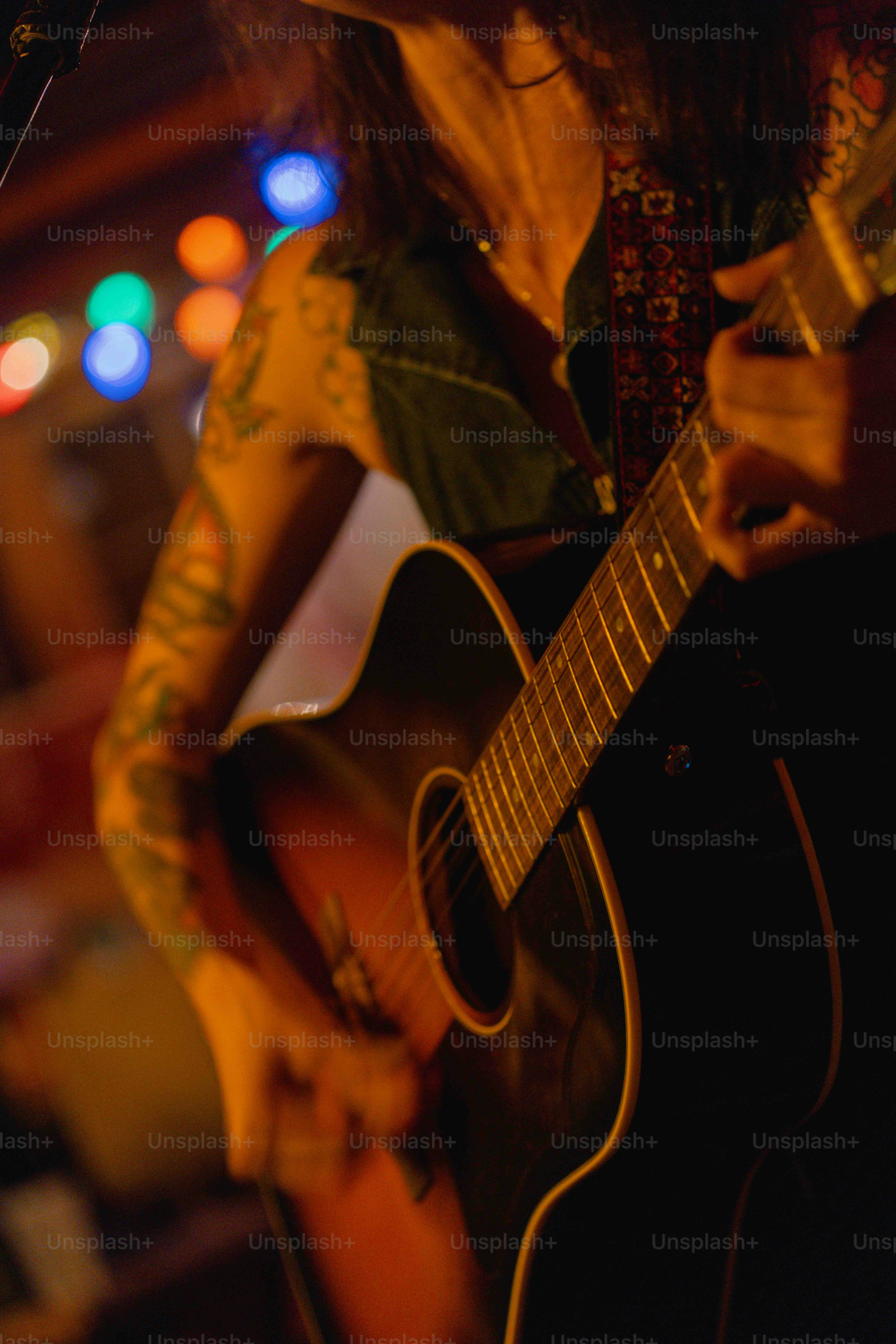 A man with long hair playing a guitar