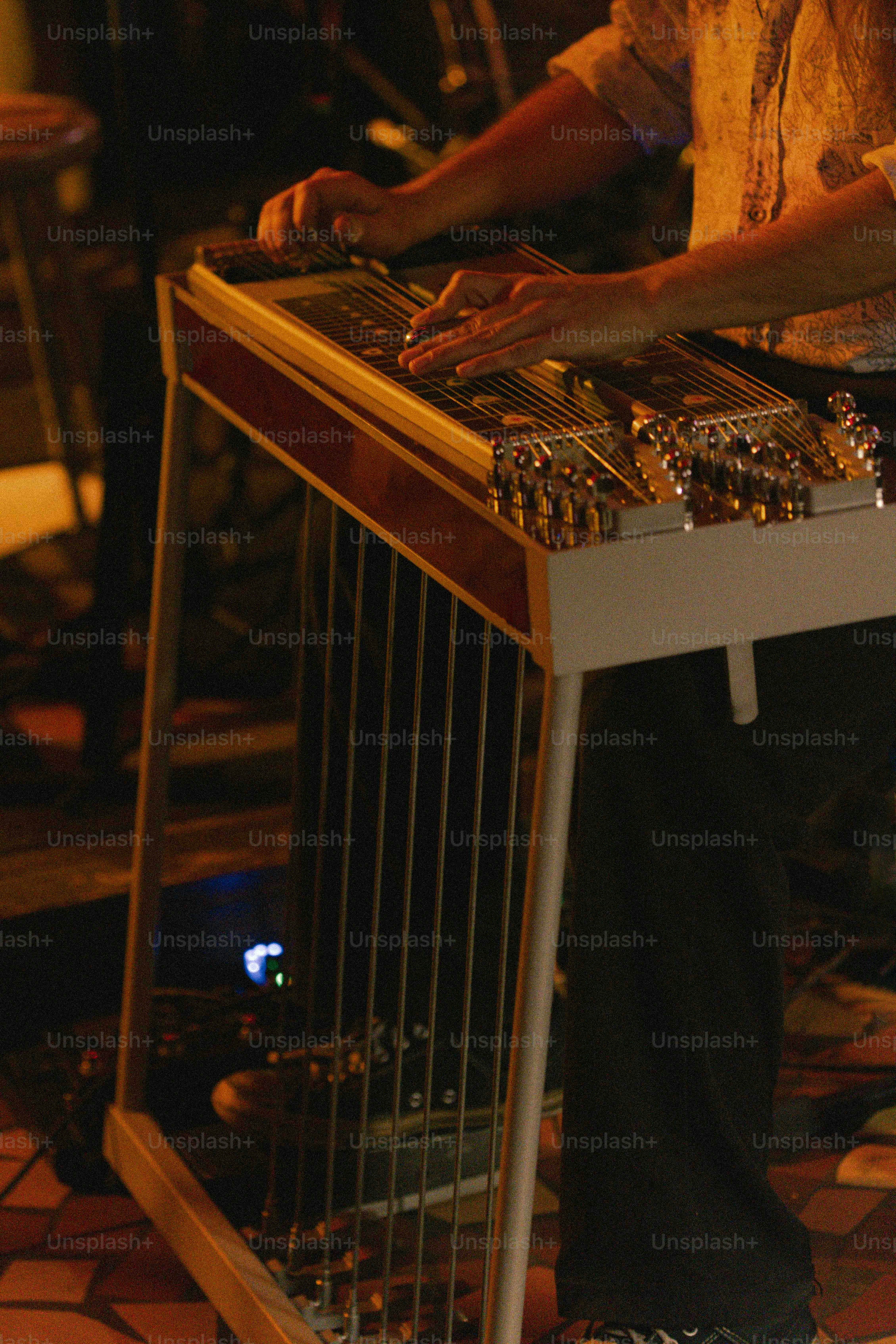 A man sitting at a table with a musical instrument