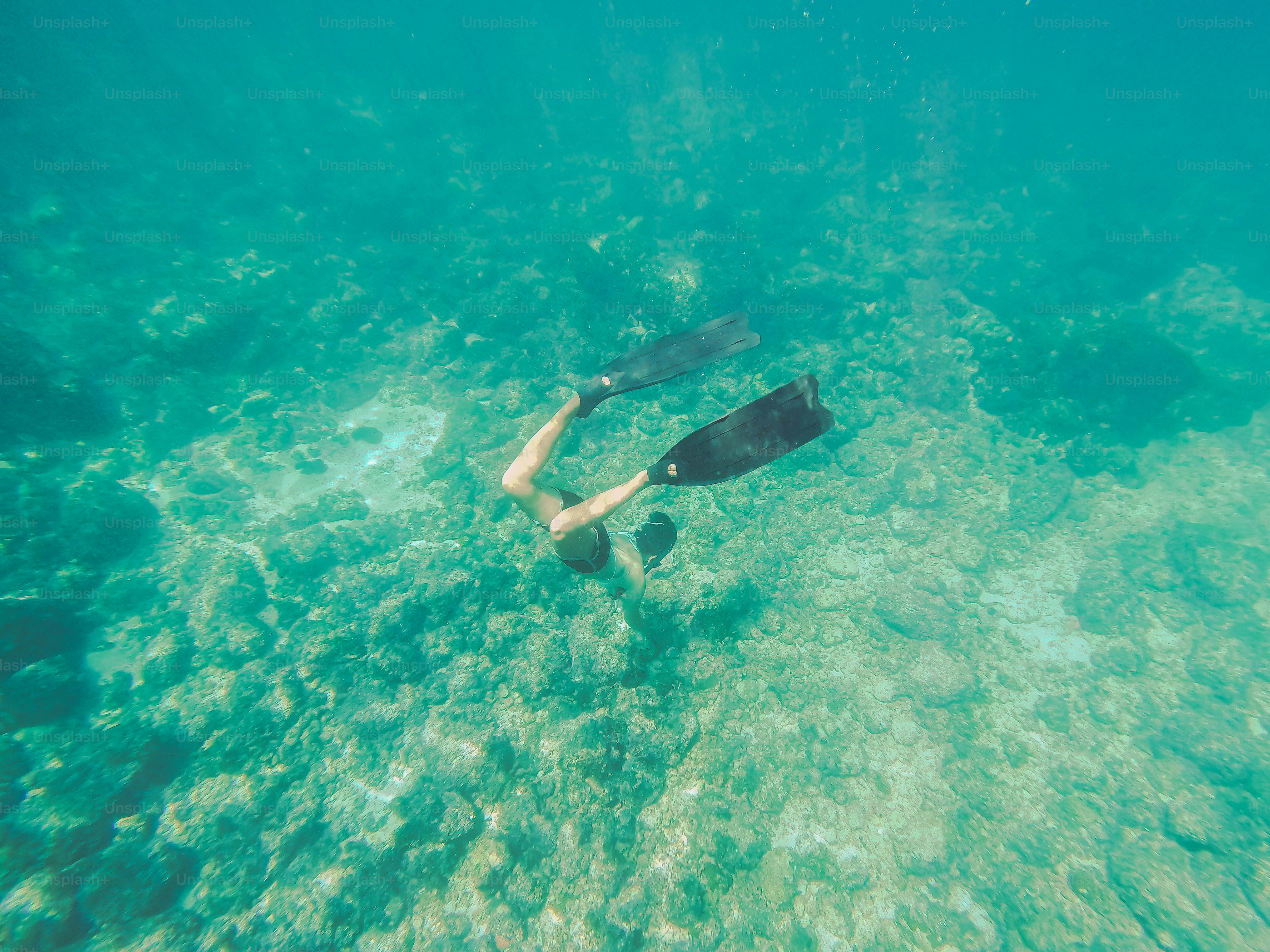 A person swimming in the ocean with a mask on