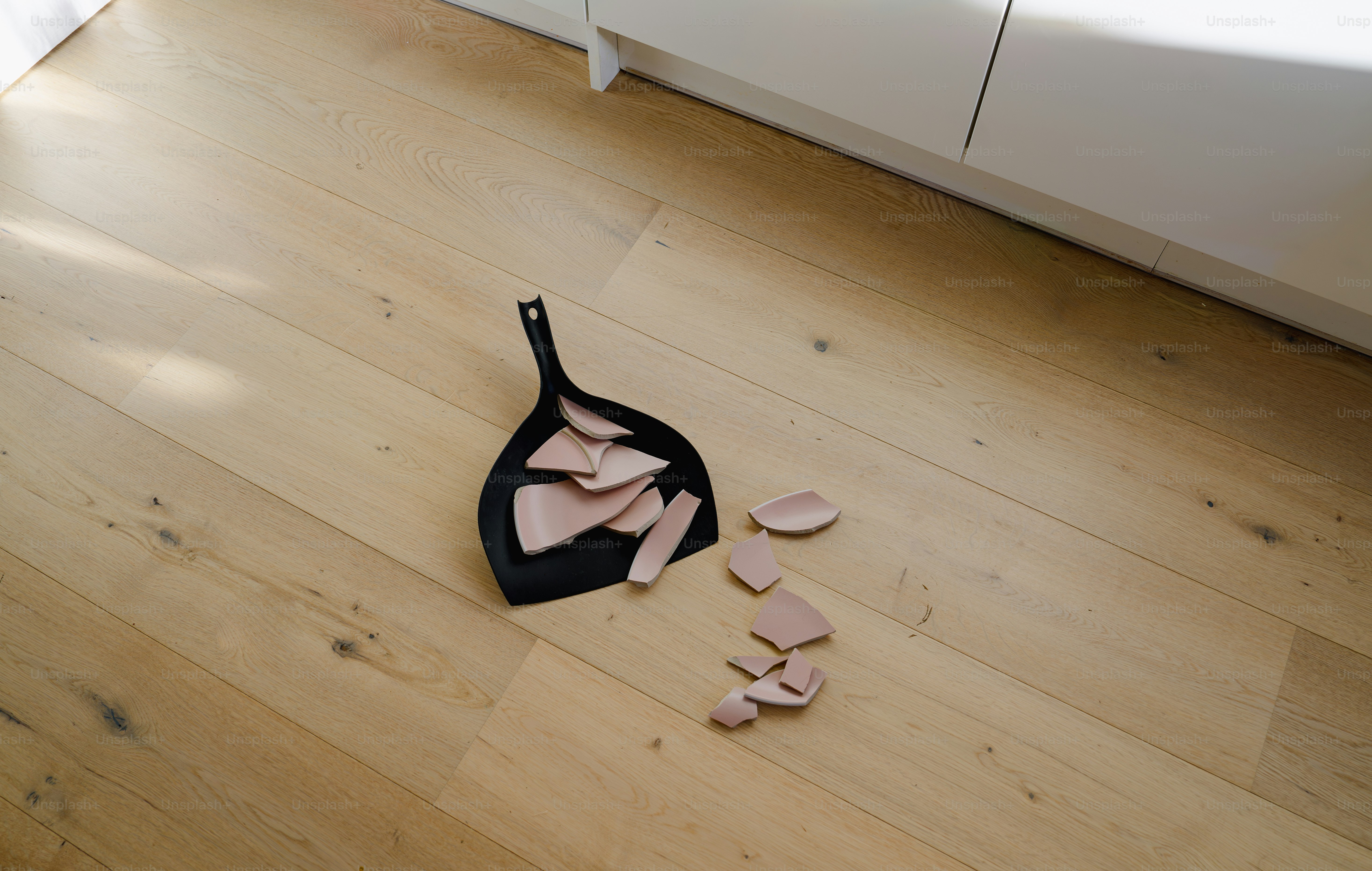 A pair of high heeled shoes laying on the floor next to a pair of