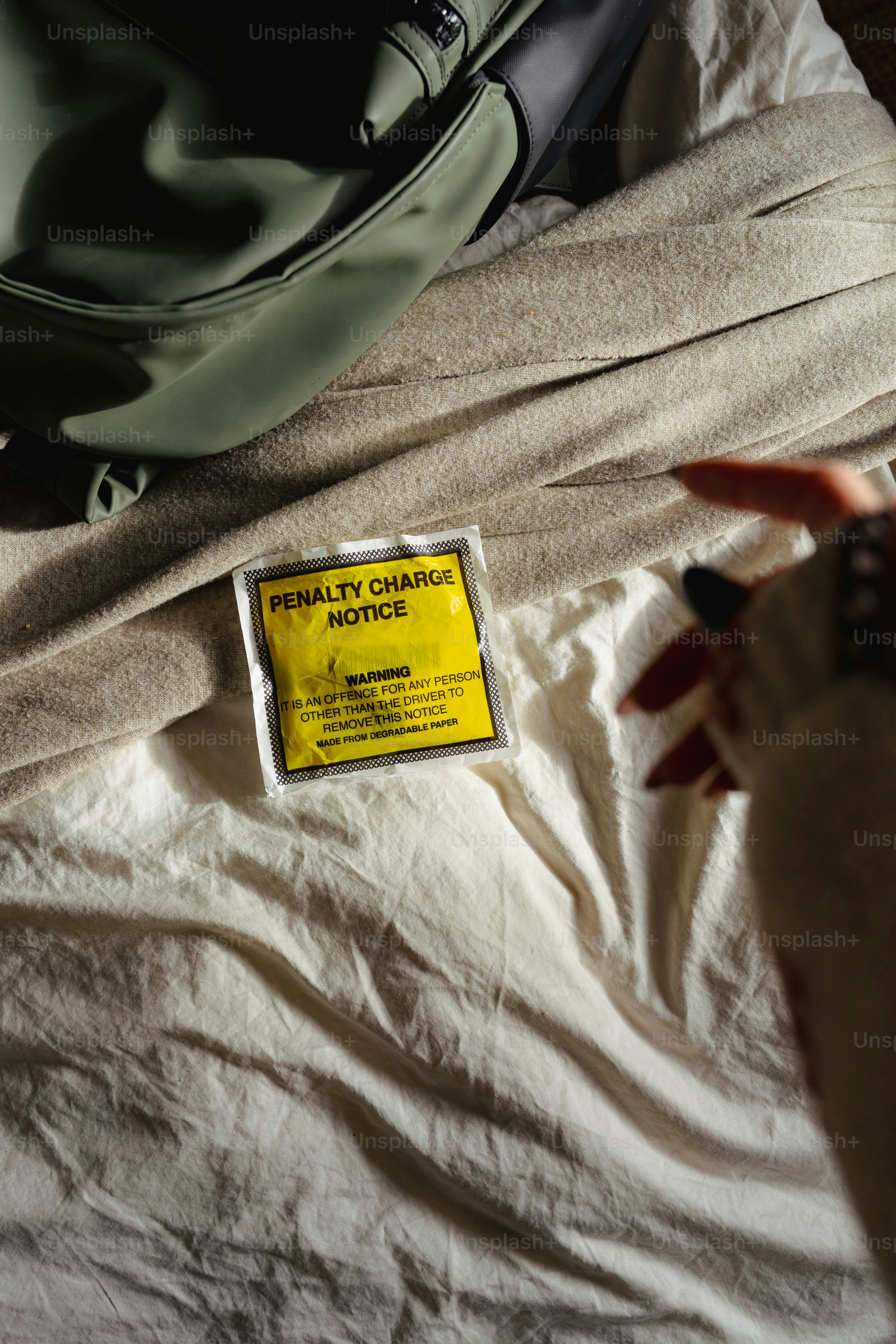 A bed with a white sheet and a yellow label on it