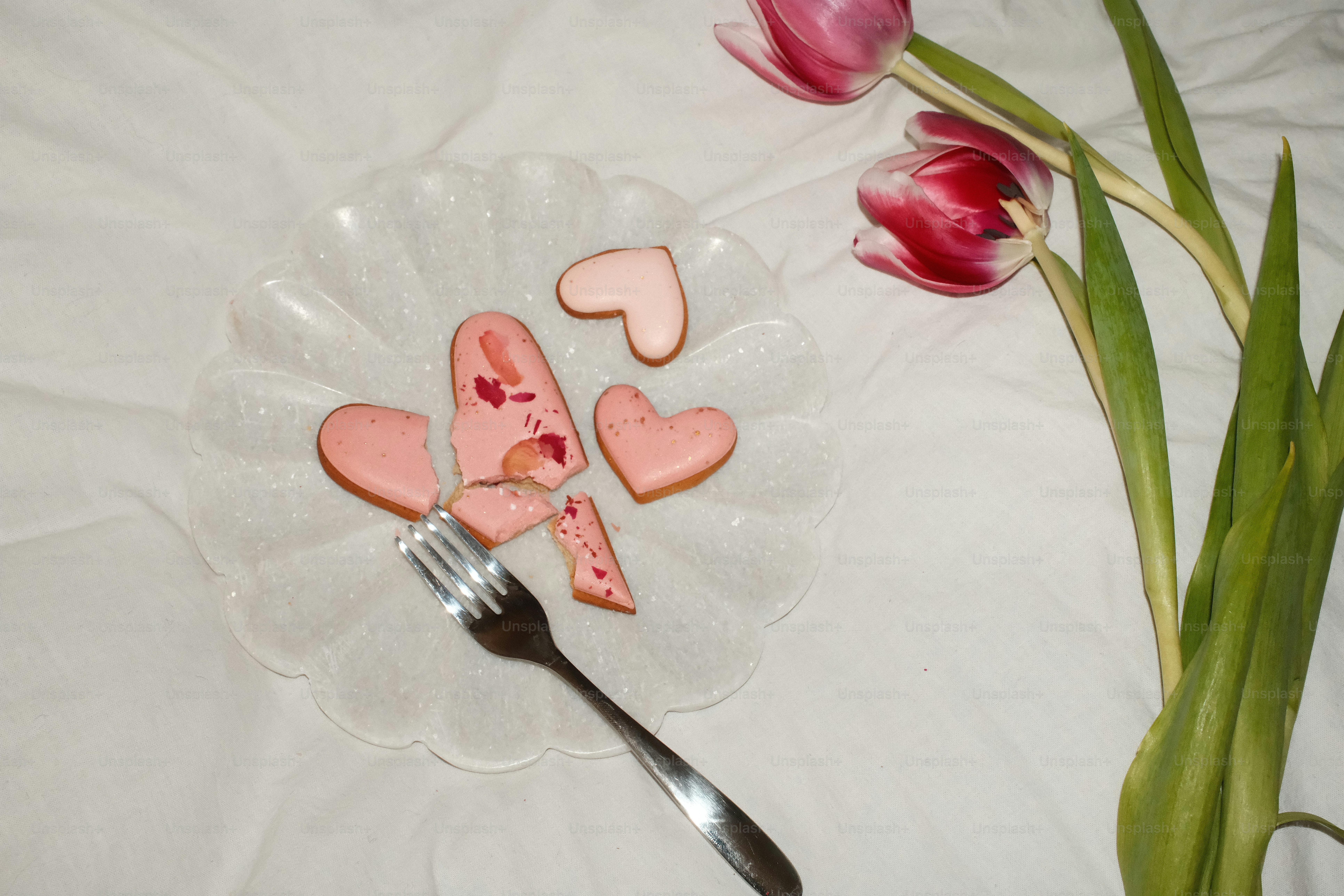 A couple of pink hearts sitting on top of a plate
