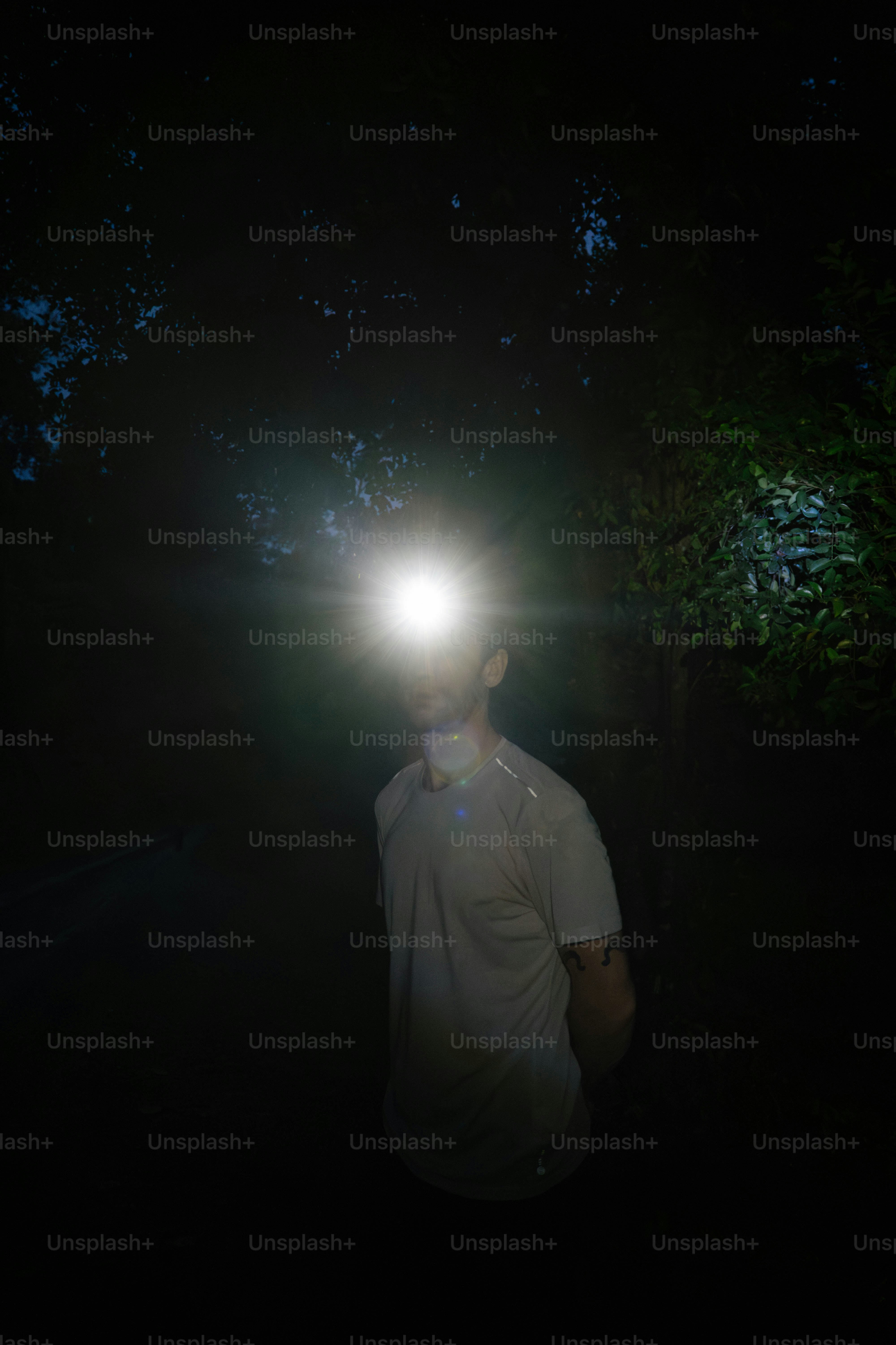 A man standing in the dark with a light on his head